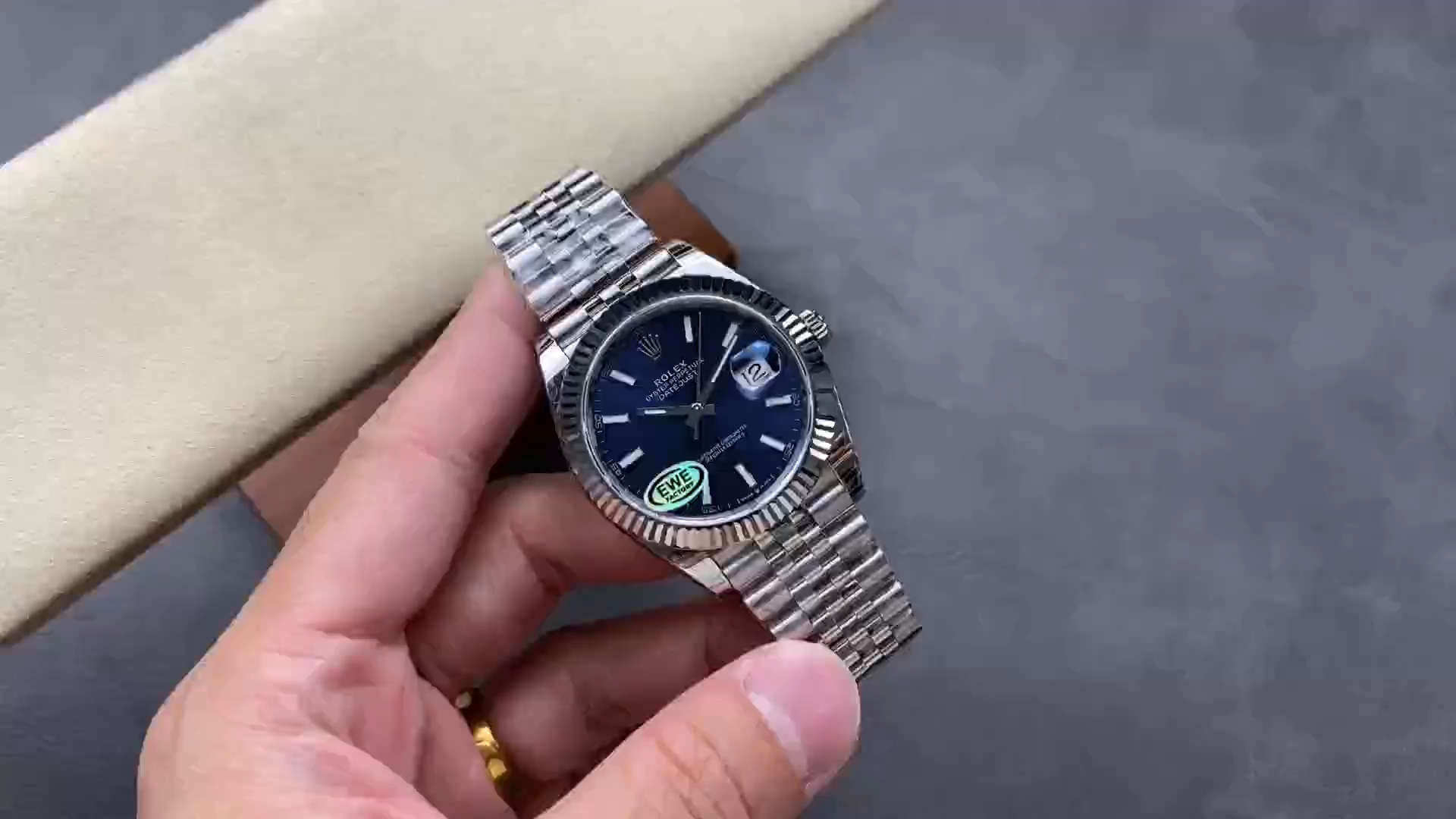 Video of Rolex Datejust 36 126234 showing the watch held in hand from the front. - Video