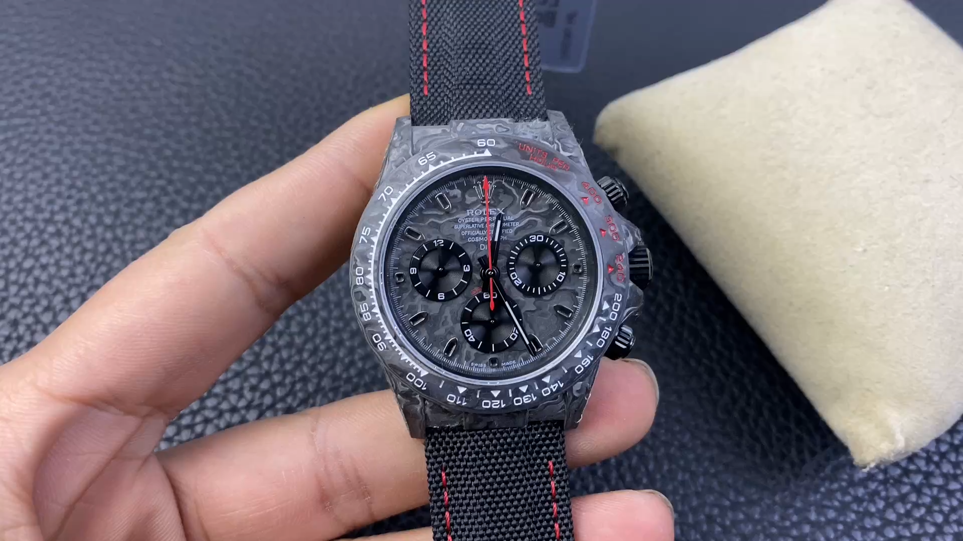 Hand holding the Rolex Cosmograph Daytona DIW Speedster, front dial view. - Video