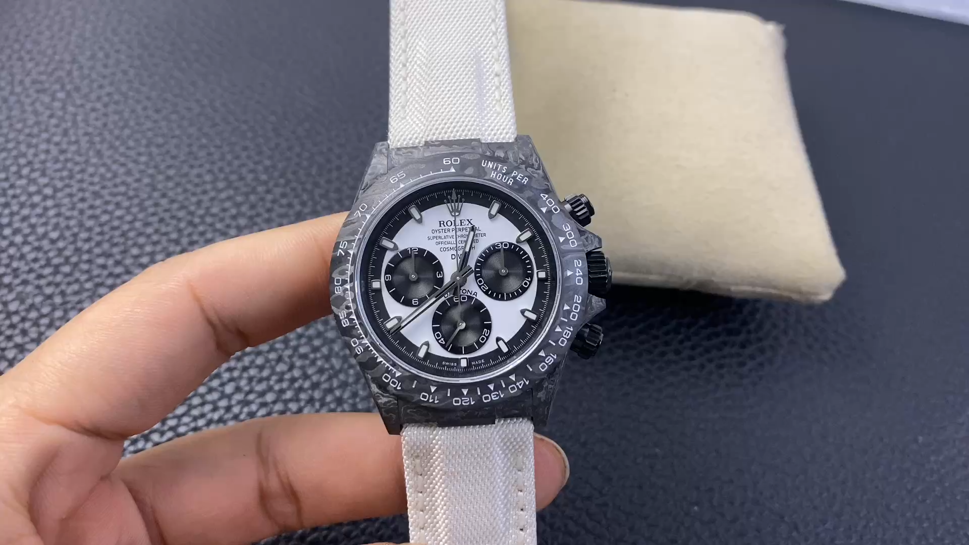 Rolex Daytona DIW Carbonfiber 40, video showing the watch on a cushion. - Video