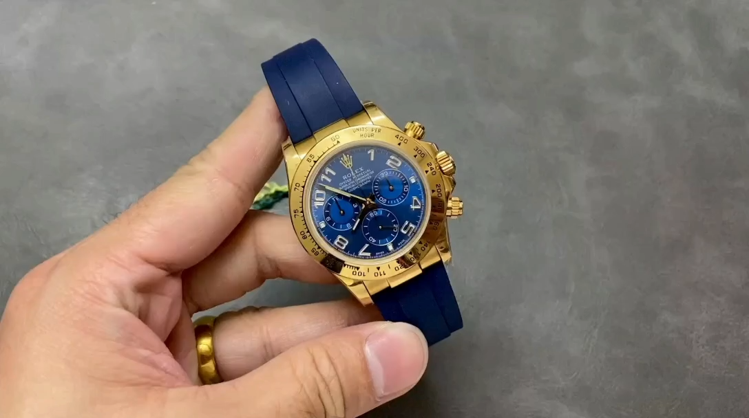 Video of the Rolex Daytona 116518 shown in hand, blue dial and gold case. - Video