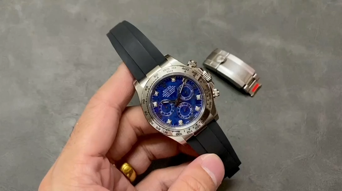 Video of the Rolex Daytona 116519 shown in hand, highlighting the blue garnet dial and diamond markers. - Video