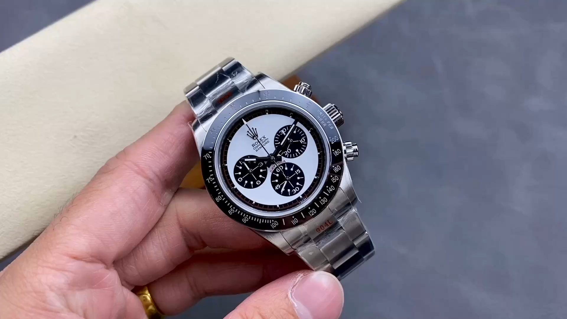 Video of the Rolex Daytona 116520 Bamford Paul Newman shown in hand, white dial. - Video