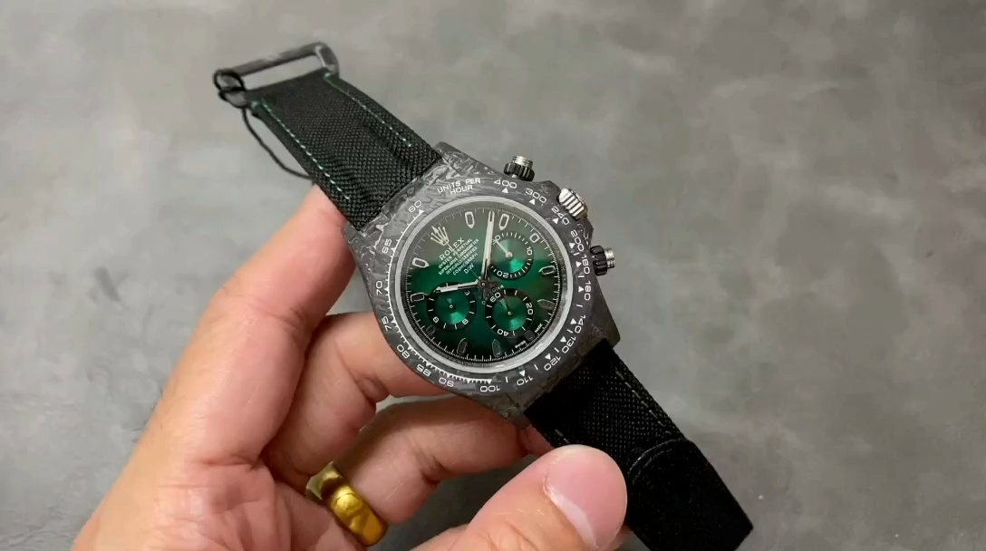 Rolex Daytona DIW 40mm, video showing the watch held in hand on a grey background. - Video