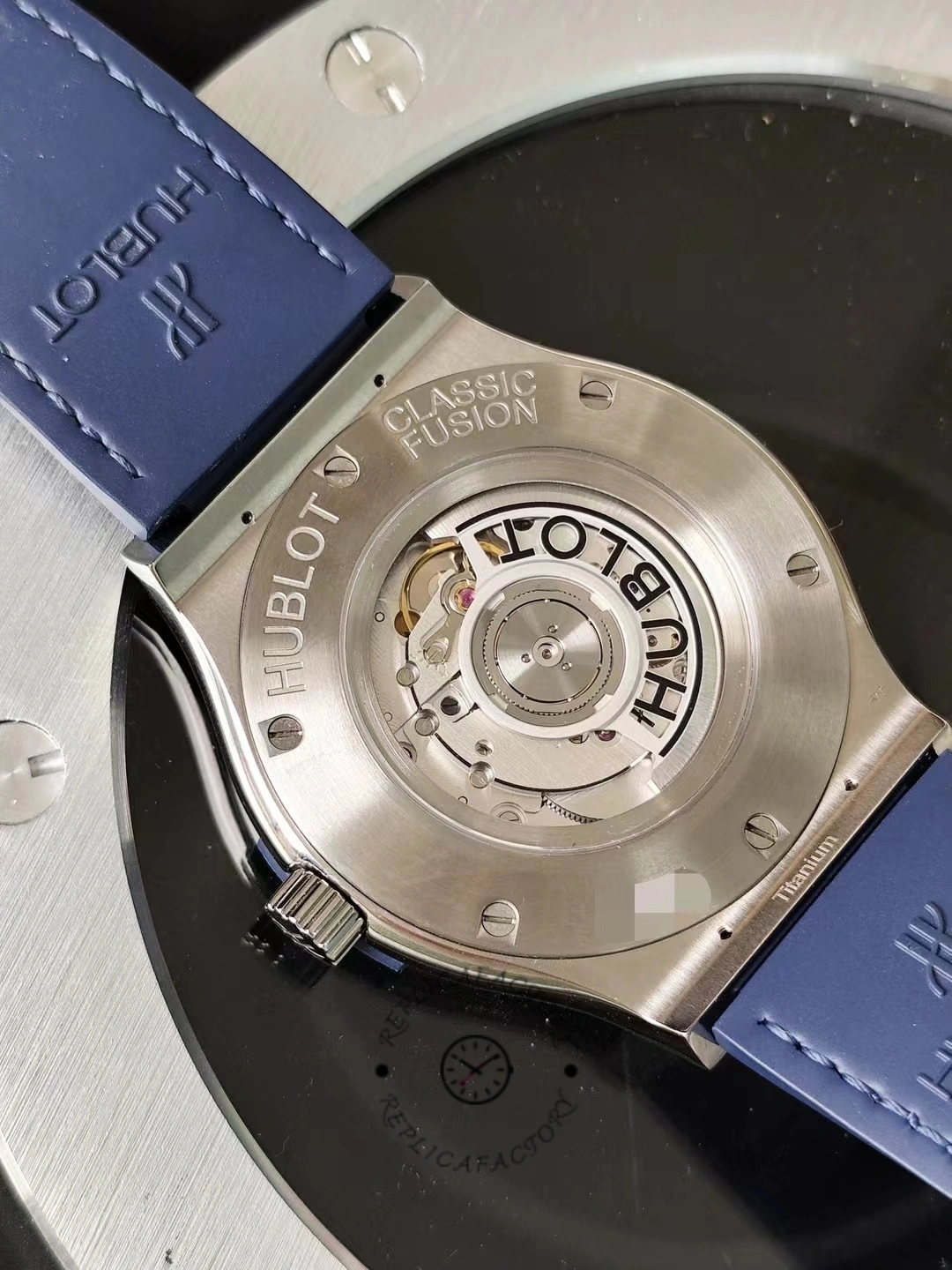 Caseback view of Hublot Classic Fusion 542.NX.7170.LR showing full engraved back on blue strap.