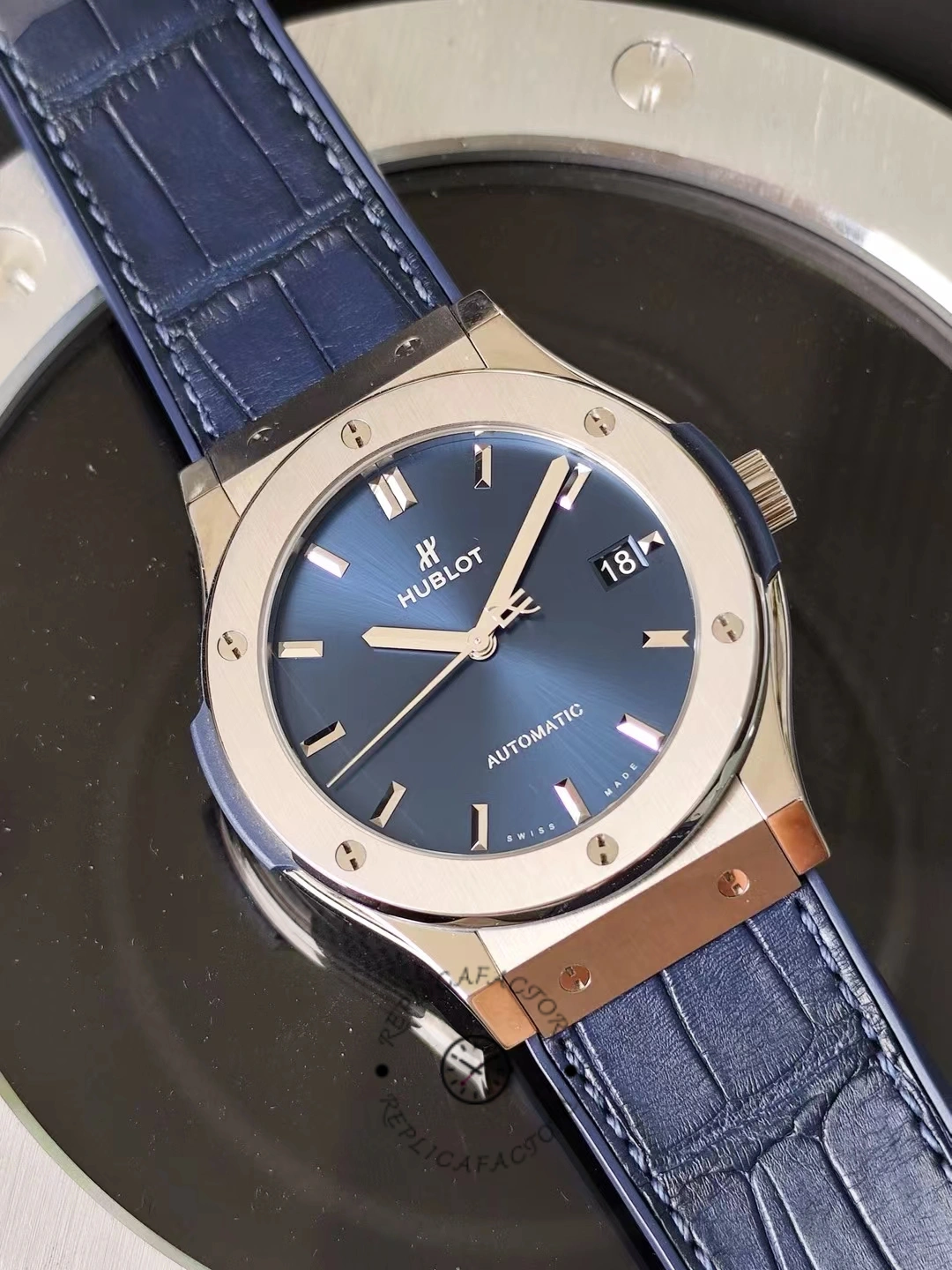 Angled full view of Hublot Classic Fusion 542.NX.7170.LR showing titanium case and blue dial on strap.