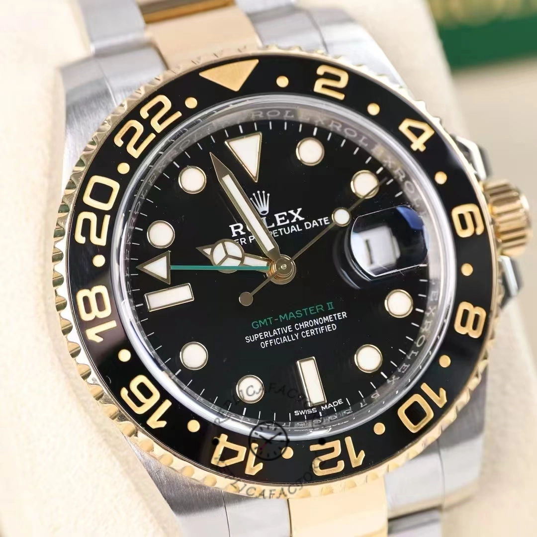 Close-up of the Rolex GMT-Master II 116713LN dial and bezel, black dial with gold details.