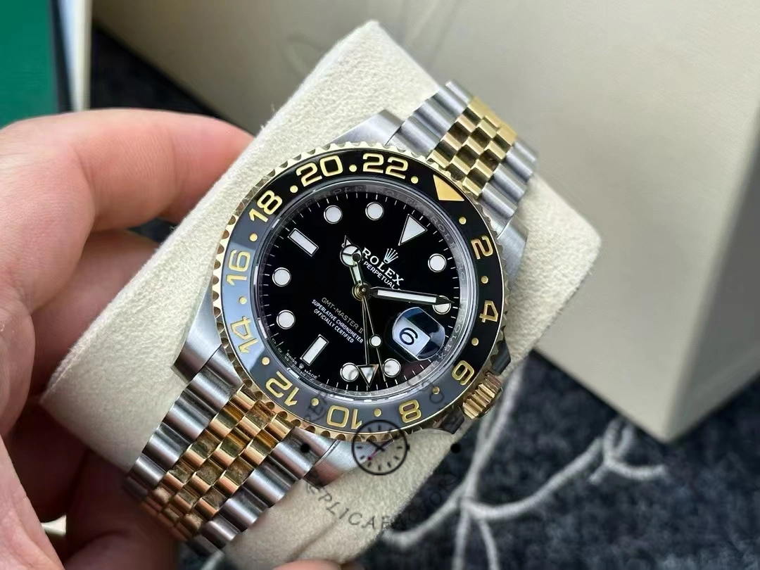 Angled view of Rolex GMT-Master II 126713GRNR-0001 showing luminous hands and gold 24-hour markers.