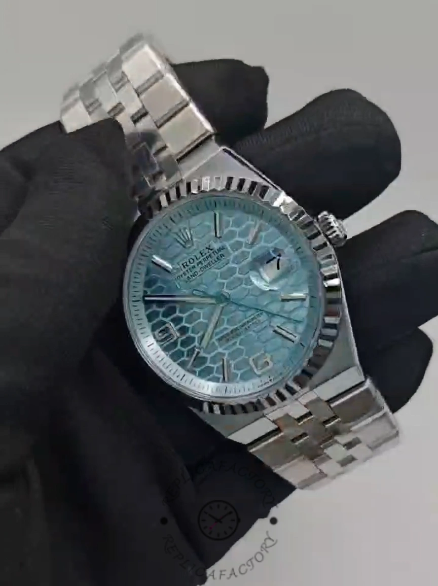 Handheld angled view of Rolex Land-Dweller 36 M127236-0001 Replica showing polished case and fluted bezel.
