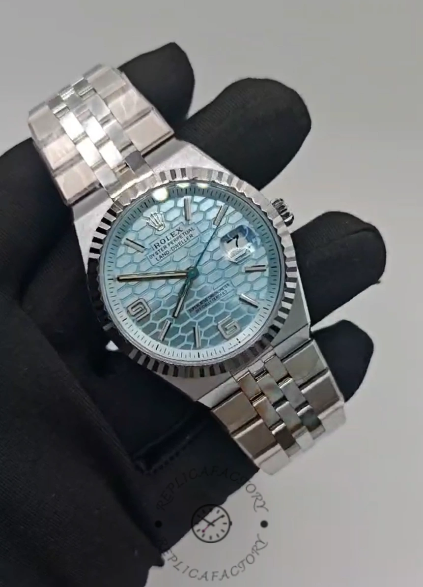 Handheld front shot of Rolex Land-Dweller 36 M127236-0001 Replica highlighting dial texture and Roman numerals.
