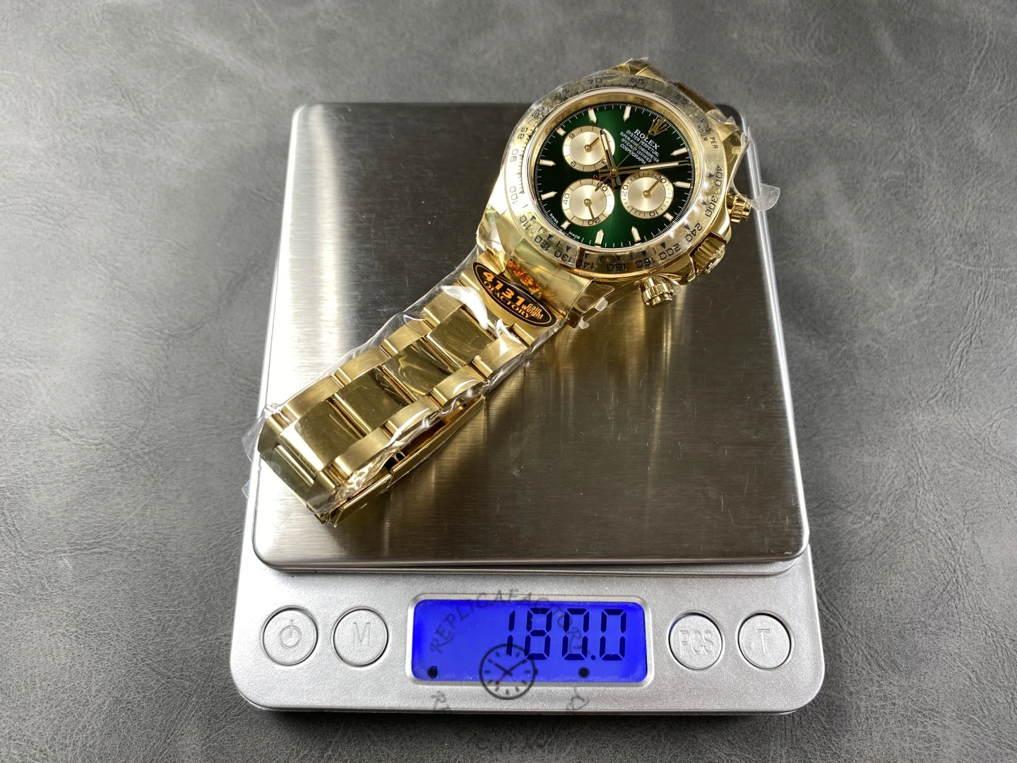 2025 Rolex Cosmograph Daytona 126508 0008 on scale, yellow gold case and bracelet, green dial.