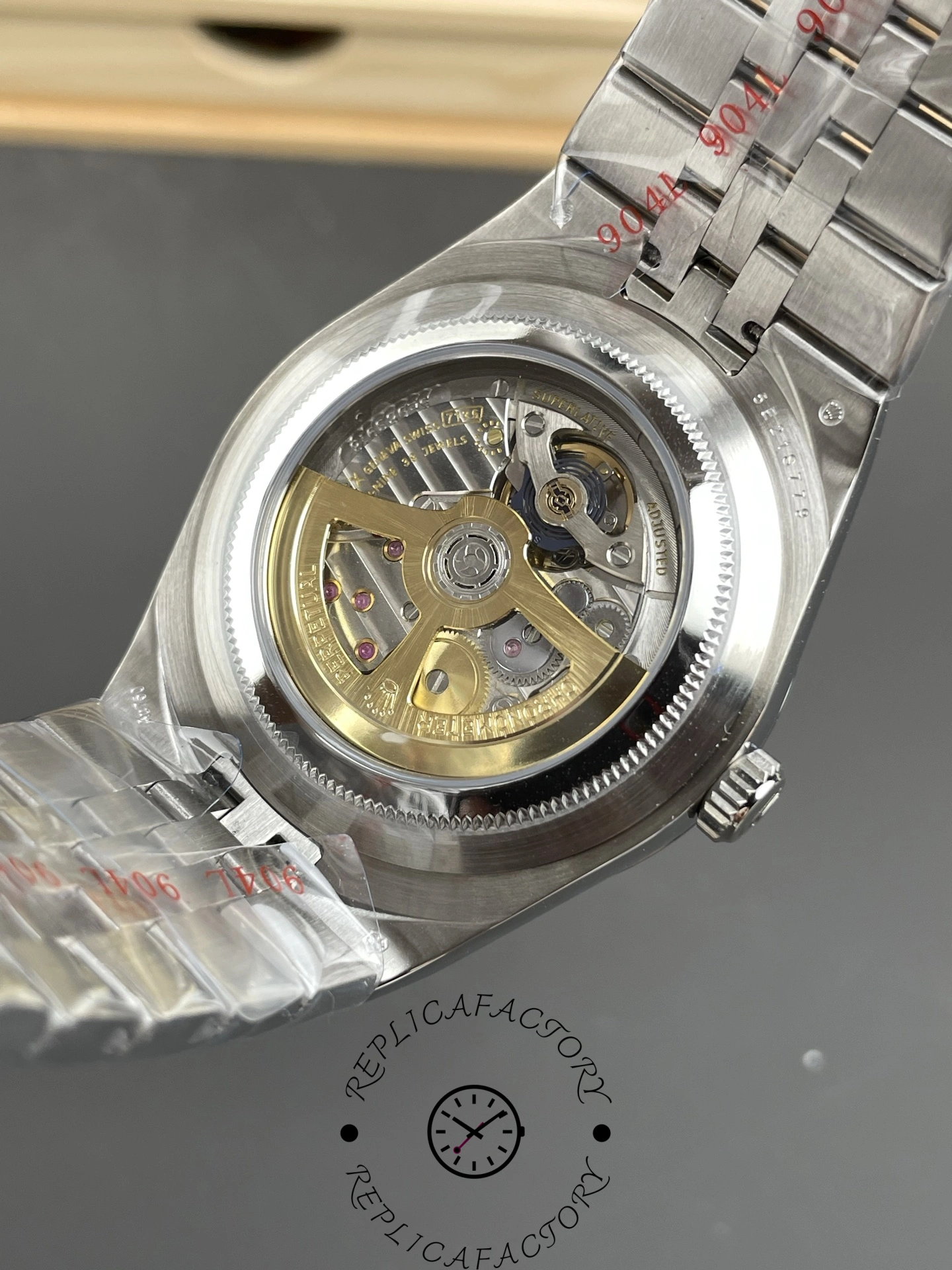 Transparent caseback view of Rolex Land-Dweller 40 M127334-0001 Replica revealing automatic movement and rotor.