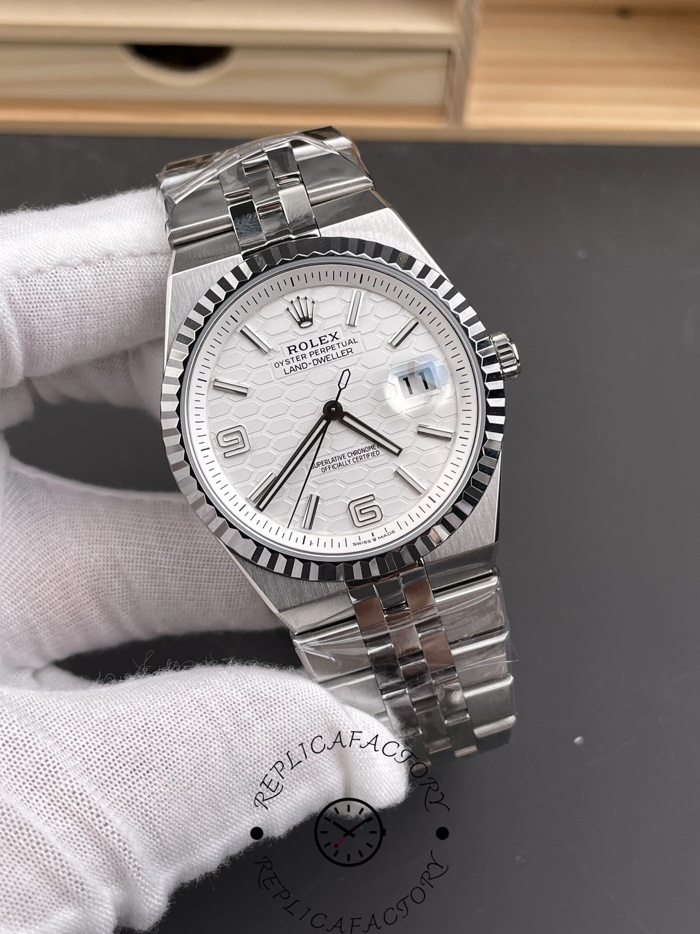 Angled front view of Rolex Land-Dweller 40 M127334-0001 Replica showing Roman numeral markers and polished case.
