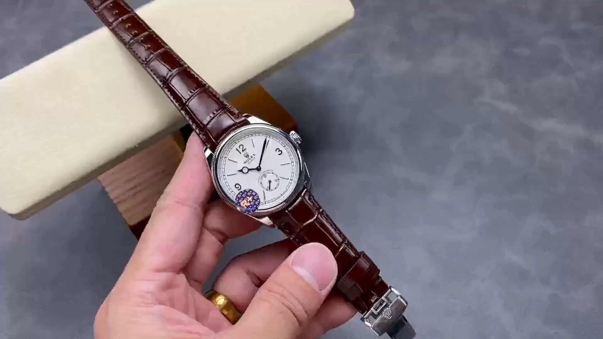 Video of Rolex 1908 52509-0006 39mm replica showing brown leather strap and buckle held in hand.