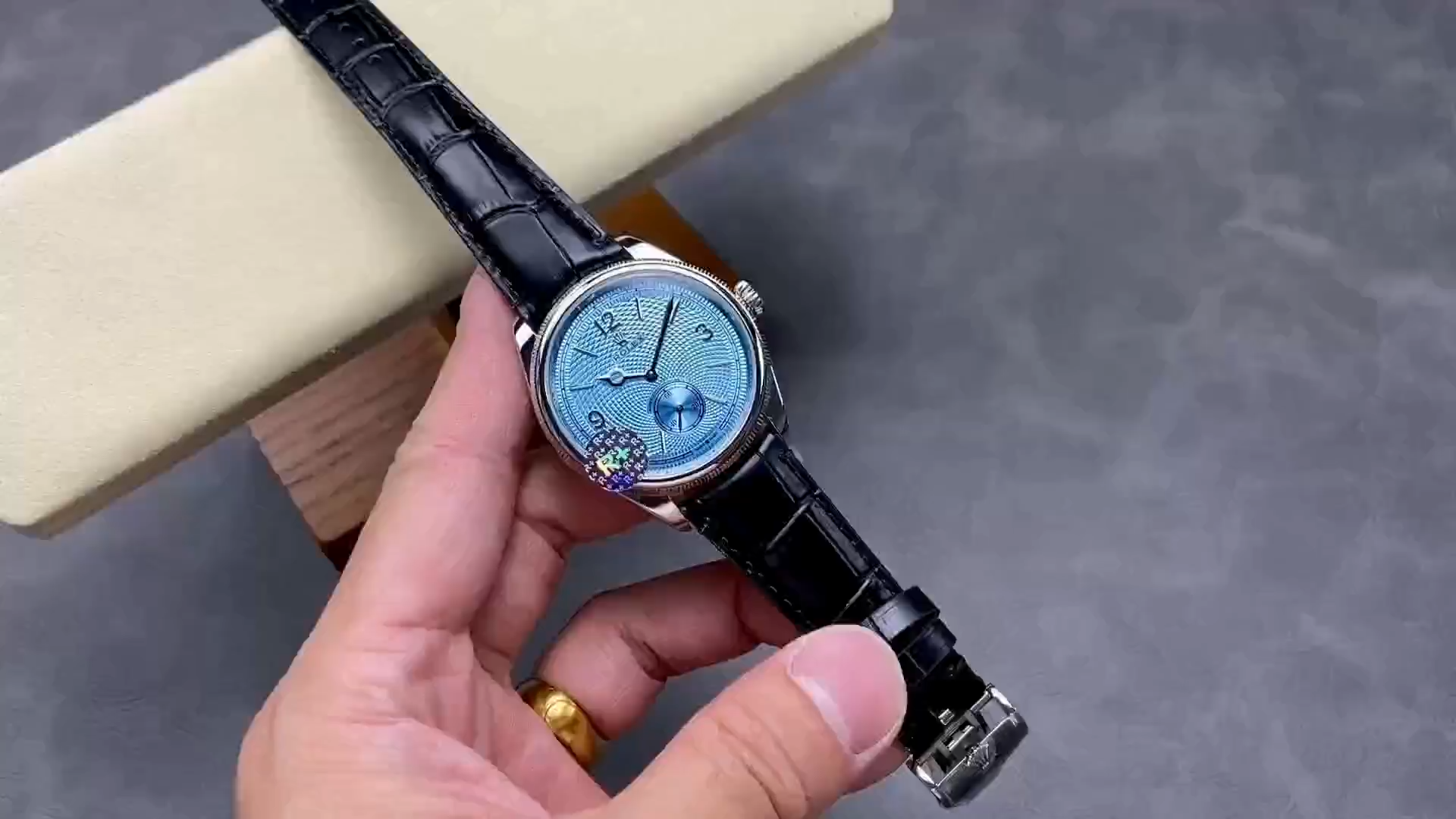 Video showing the Rolex 1908 52506-0003 replica rotating, highlighting the ice blue dial and polished case.