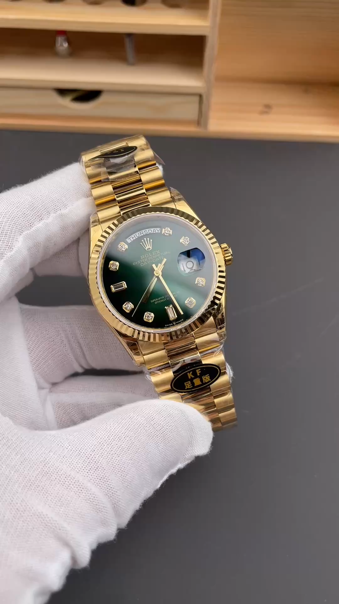 Video of Rolex Day-Date 128238 held in hand showing green dial and yellow gold bracelet. - Video