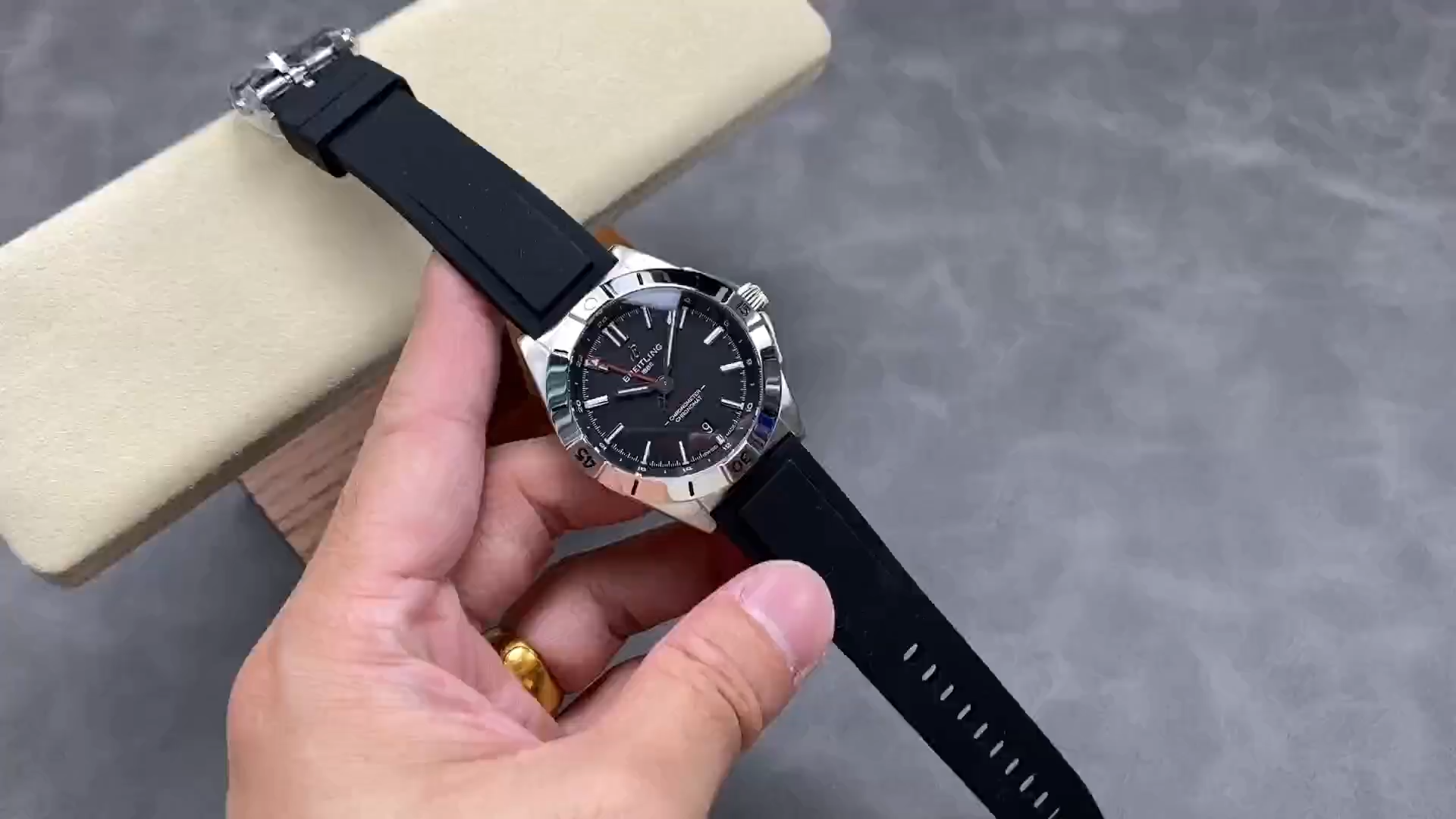 Breitling Chronomat GMT 40 A32398101B1A1, video showing dial and black rubber strap on cushion. - Video