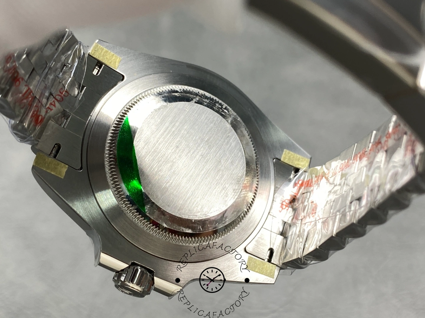 Rolex GMT-Master II 126710BLNR case back view, stickered back and Jubilee bracelet, rear angle.