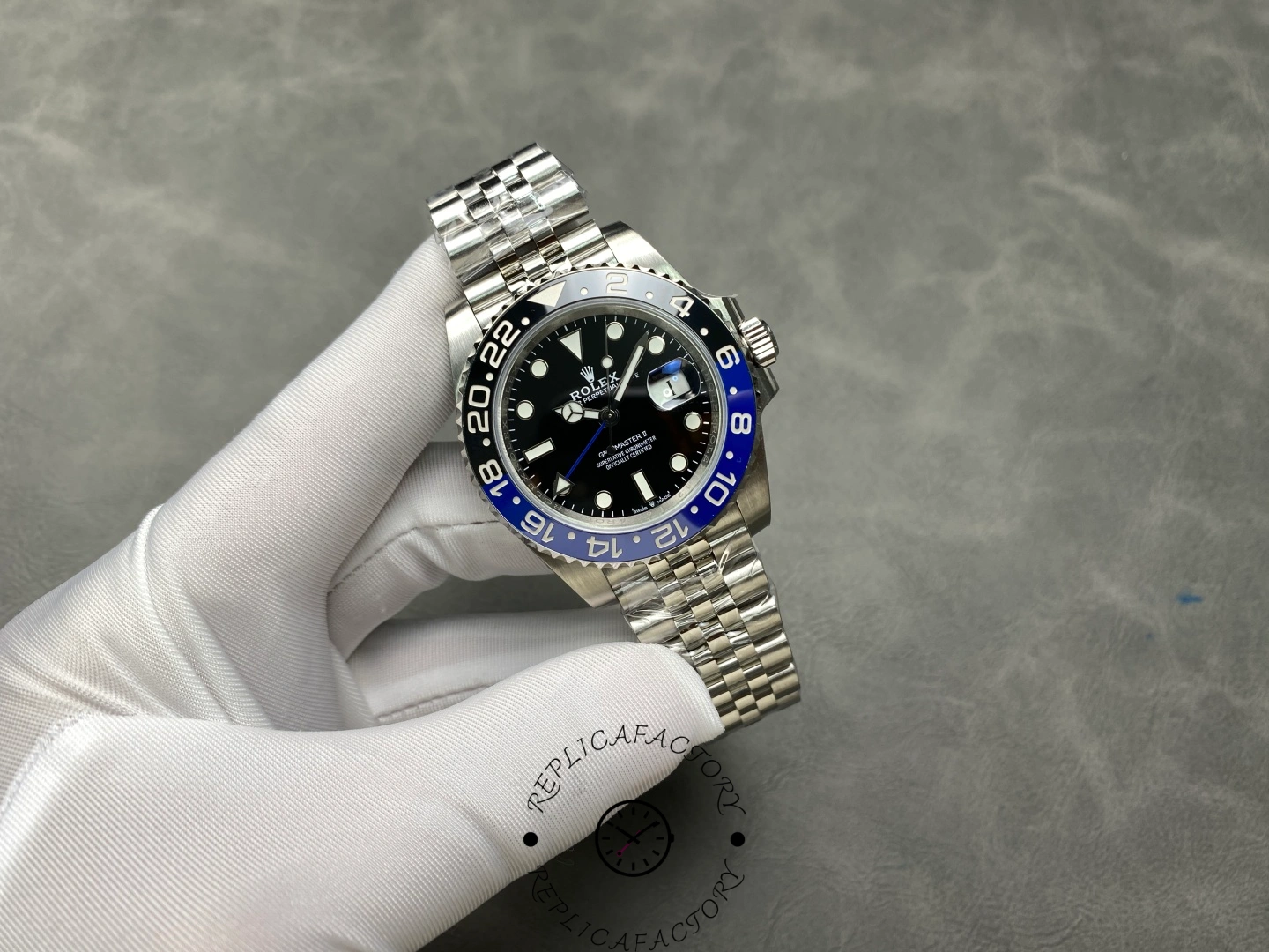 Rolex GMT-Master II 126710BLNR small watch in glove, black dial and Batman bezel, full view.