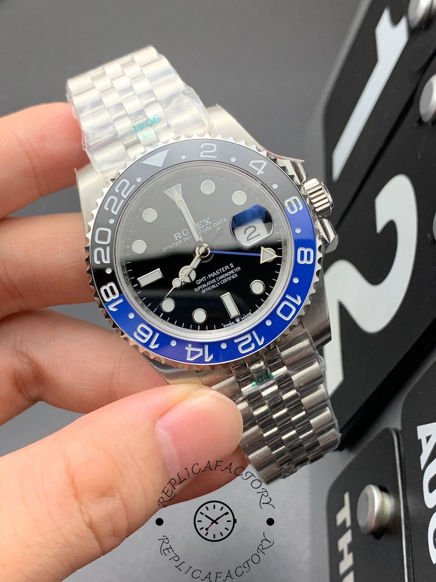 Rolex GMT-Master II 126710BLNR in hand, close view of black dial and Batman bezel.