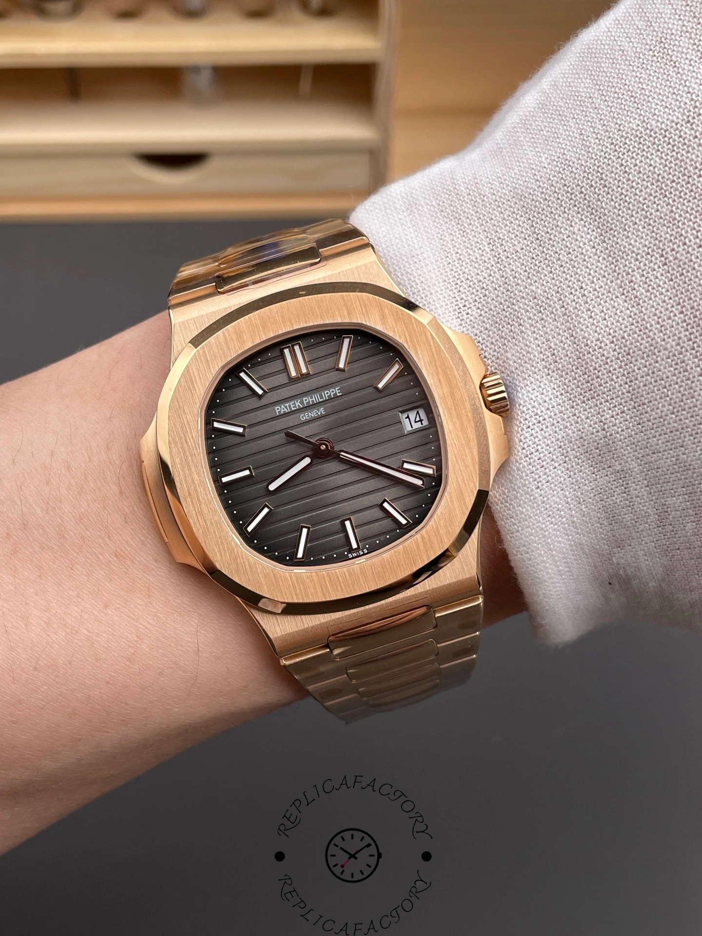 Wrist shot of Patek Philippe Nautilus 5711/1R-001 showing brown dial and rose-gold bracelet on wrist.