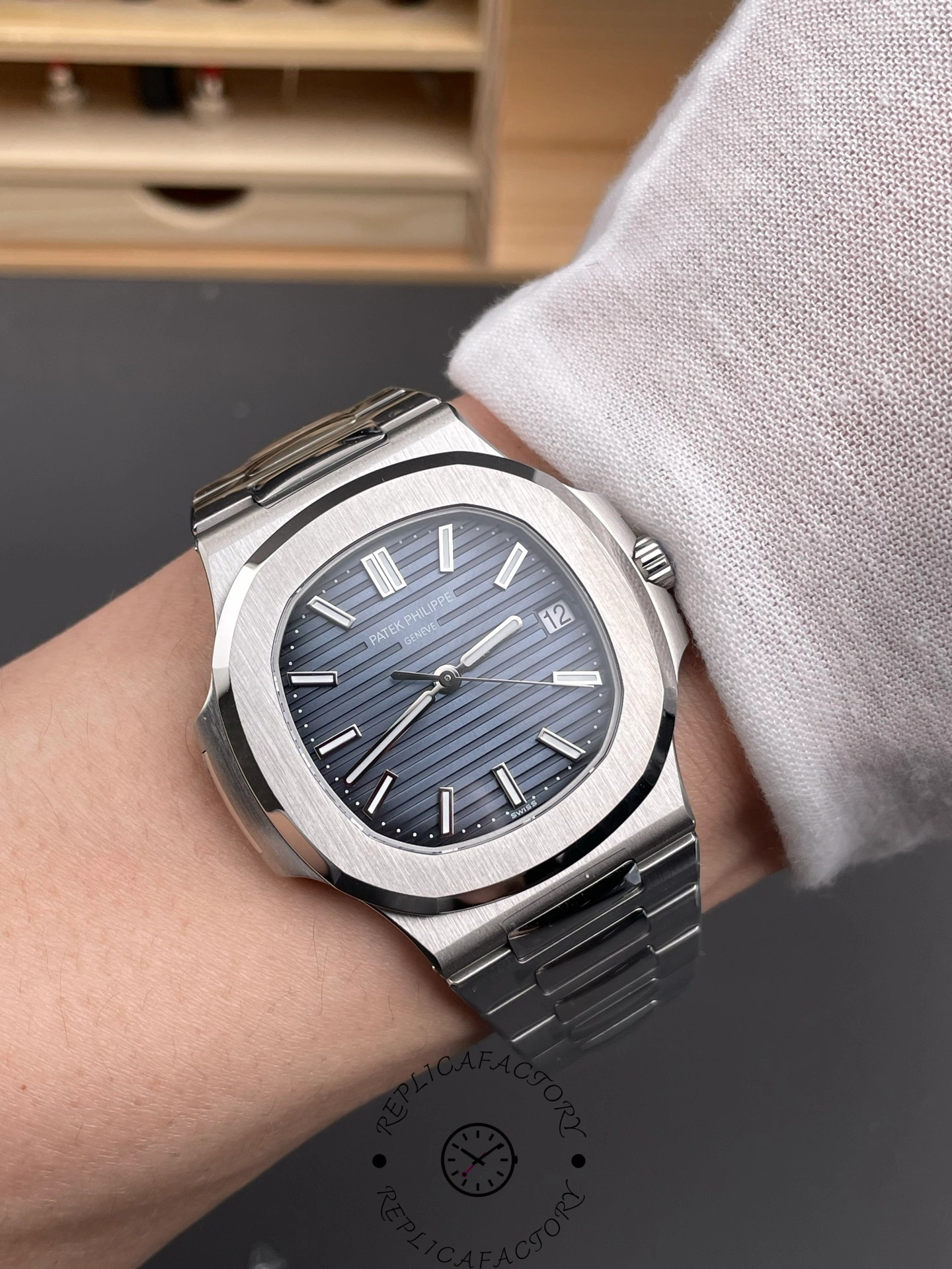 Wrist shot of Patek Philippe Nautilus 5711/1A showing blue dial and steel bracelet on wrist.