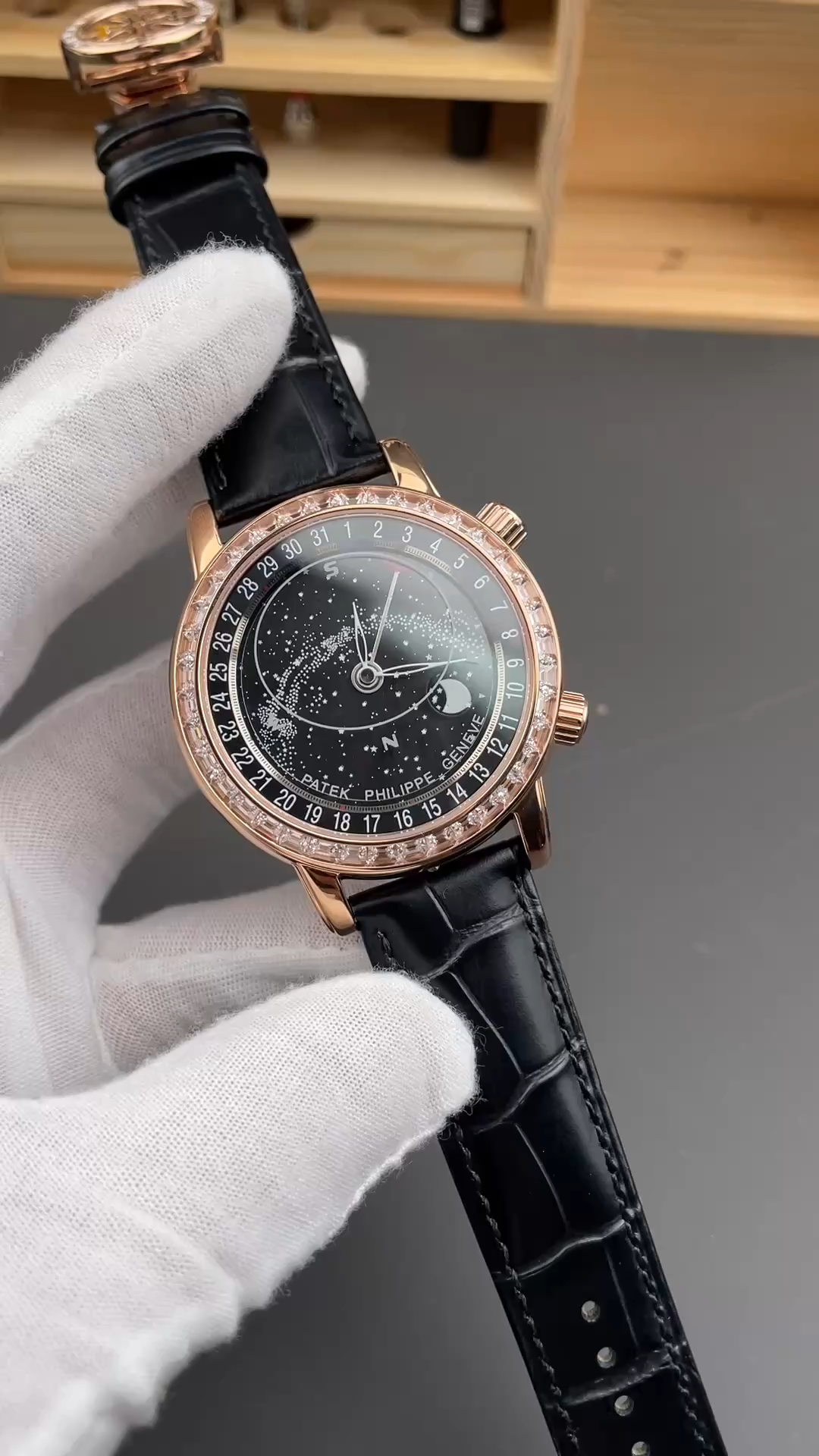 Hand-held view of Patek Philippe 6104R 001 showing star chart dial and diamond-set bezel. - Video