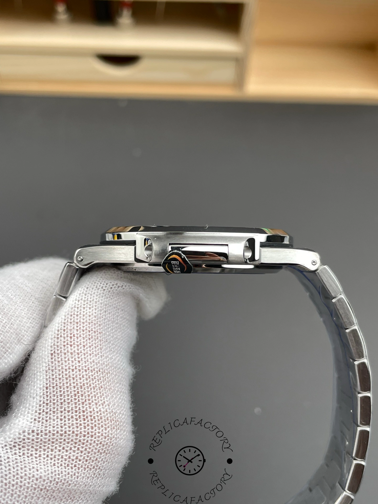 Side profile close-up of Patek Philippe Nautilus 5711/1A showing case edge and bracelet end link.