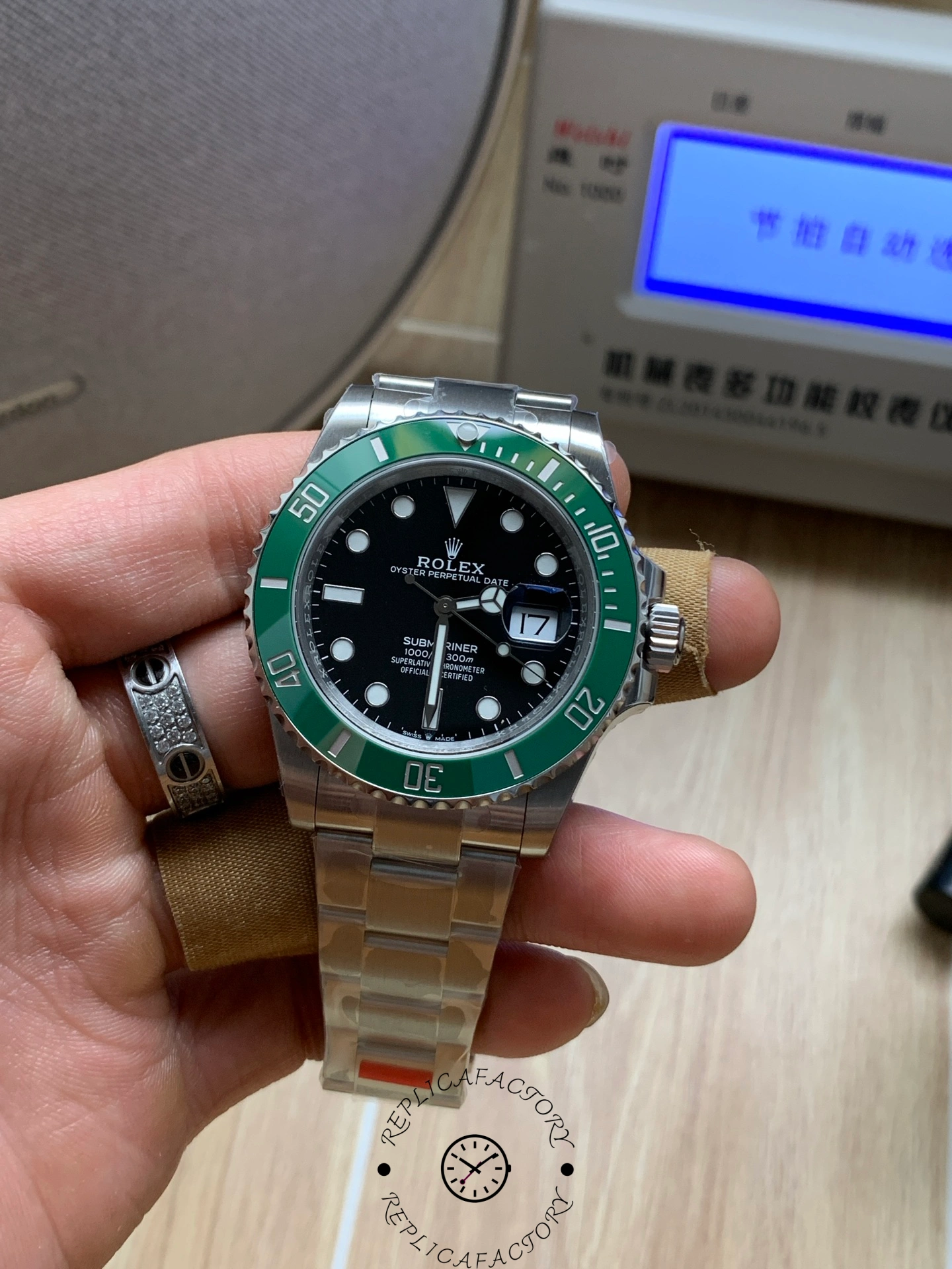 Rolex Submariner 126610LV, straight-on dial view showing black dial and green bezel numerals.