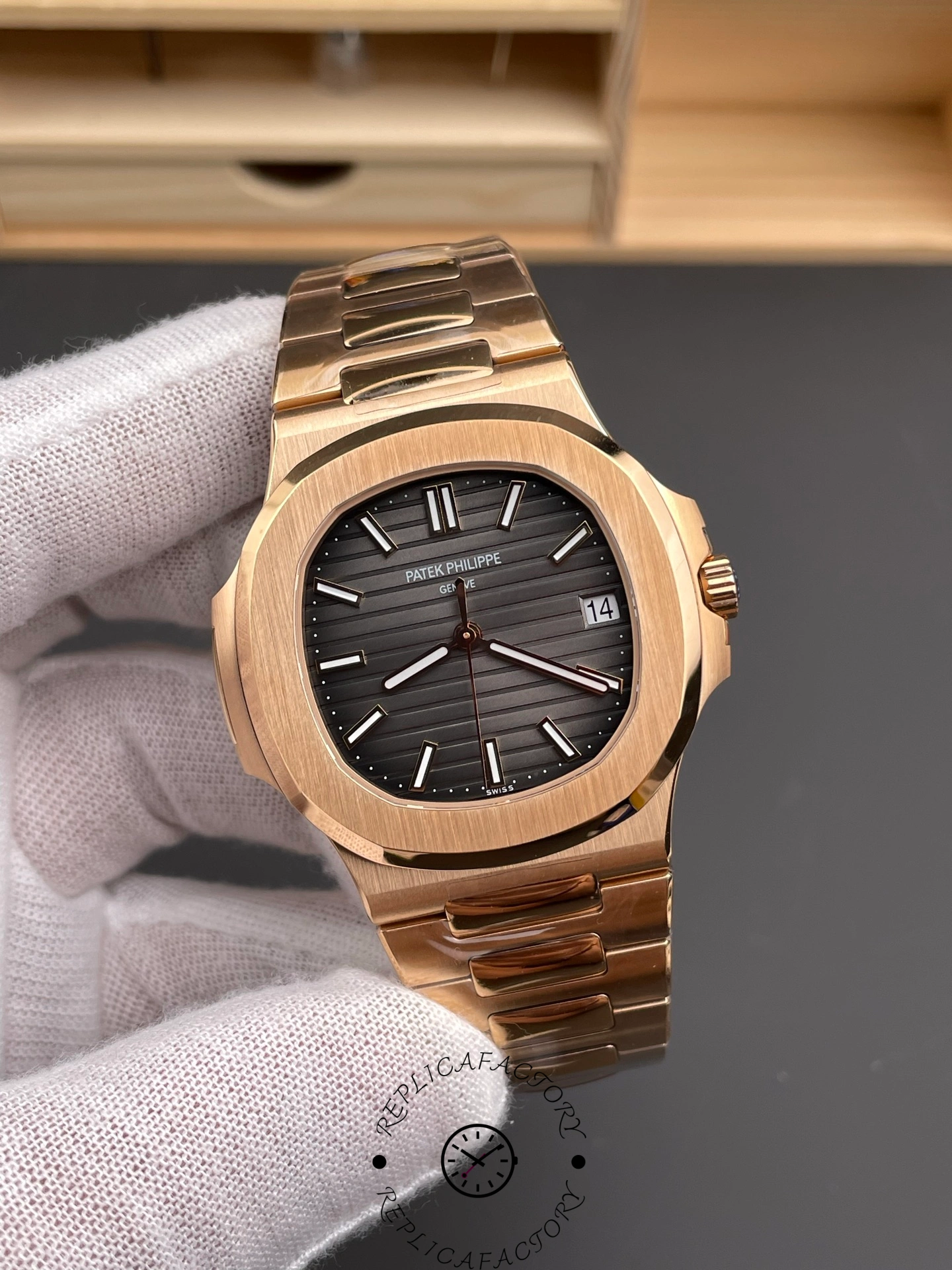 Front angle of Patek Philippe Nautilus 5711/1R-001 highlighting bezel polish and dial gradient.