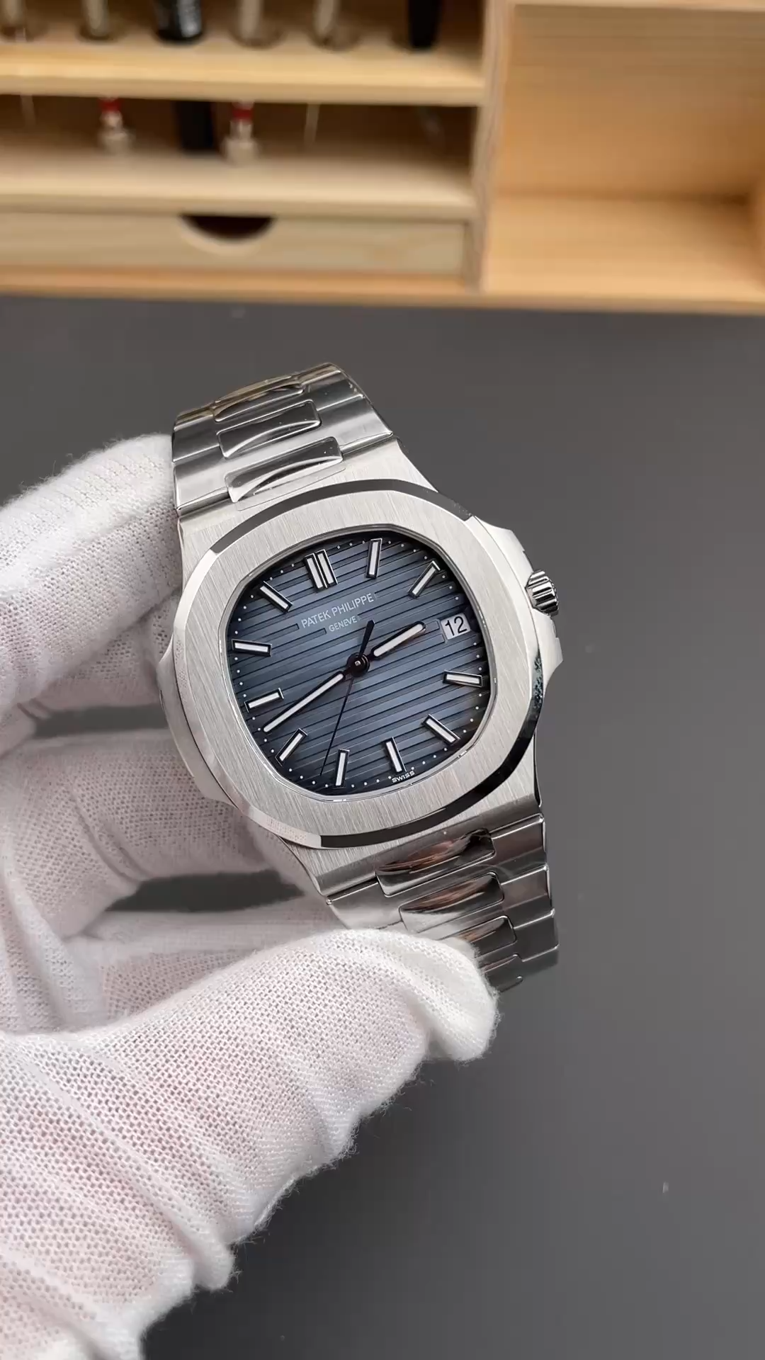 Video: glove hand close-up of Patek Philippe Nautilus 5711/1A showing dial clarity and bezel polish. - Video