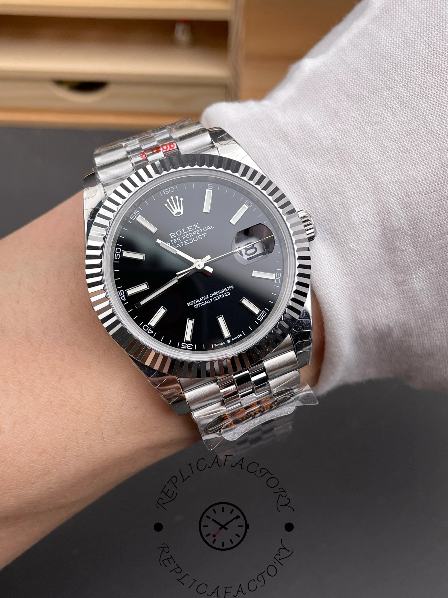 Wrist shot of the Rolex Datejust 126334-0018 with black dial and fluted bezel.