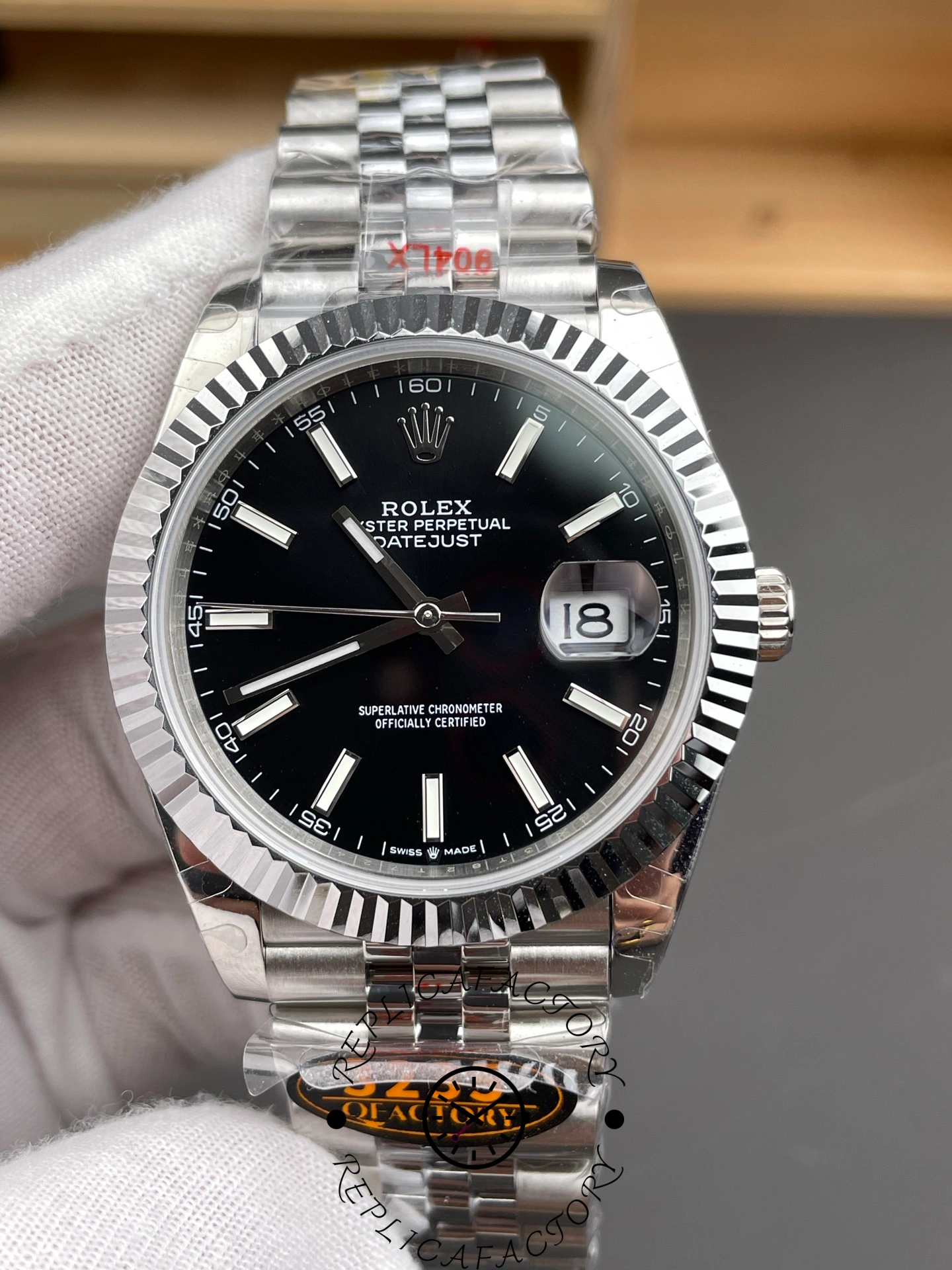Straight-on view of the Rolex Datejust 126334-0018 with black dial and polished case.