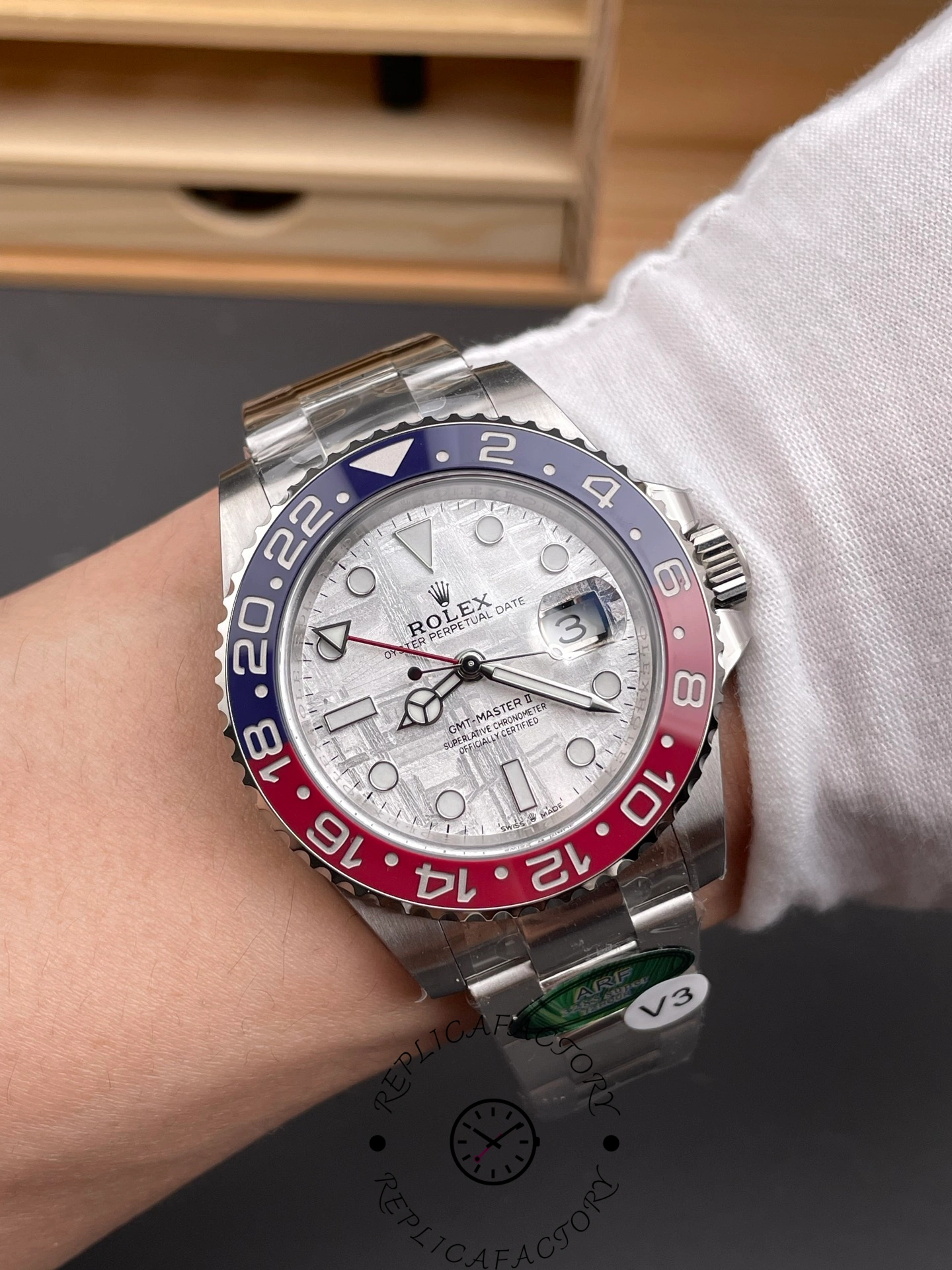 Rolex GMT-Master II 126719 0002 held in hand, meteorite dial and Pepsi bezel, front view.