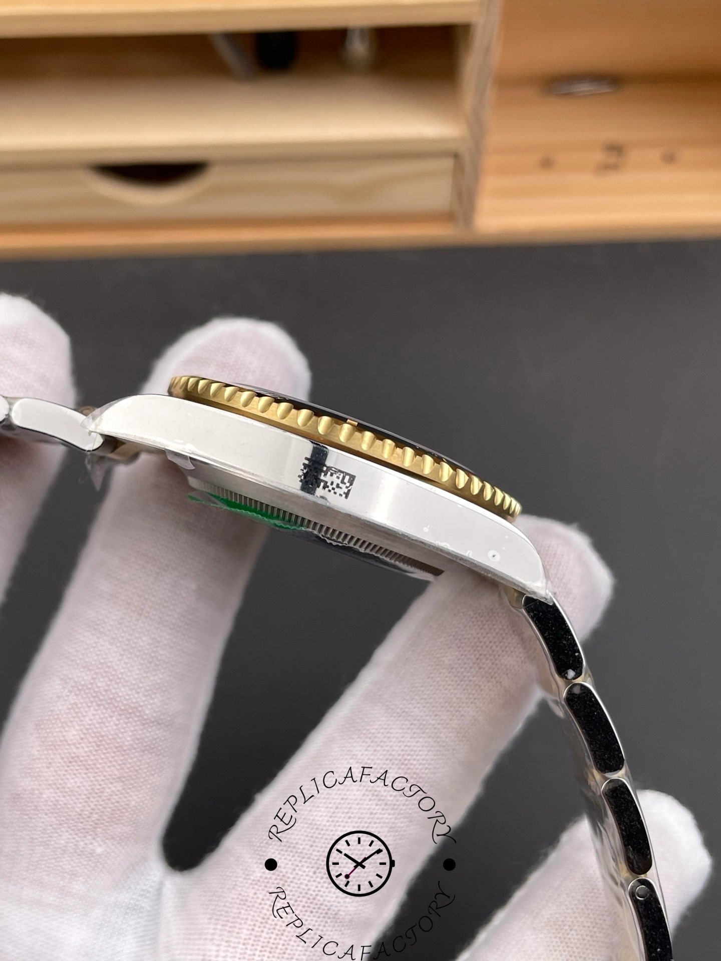 Rolex Submariner 126613LN 0002 side view on glove, bracelet links and case flank shown.