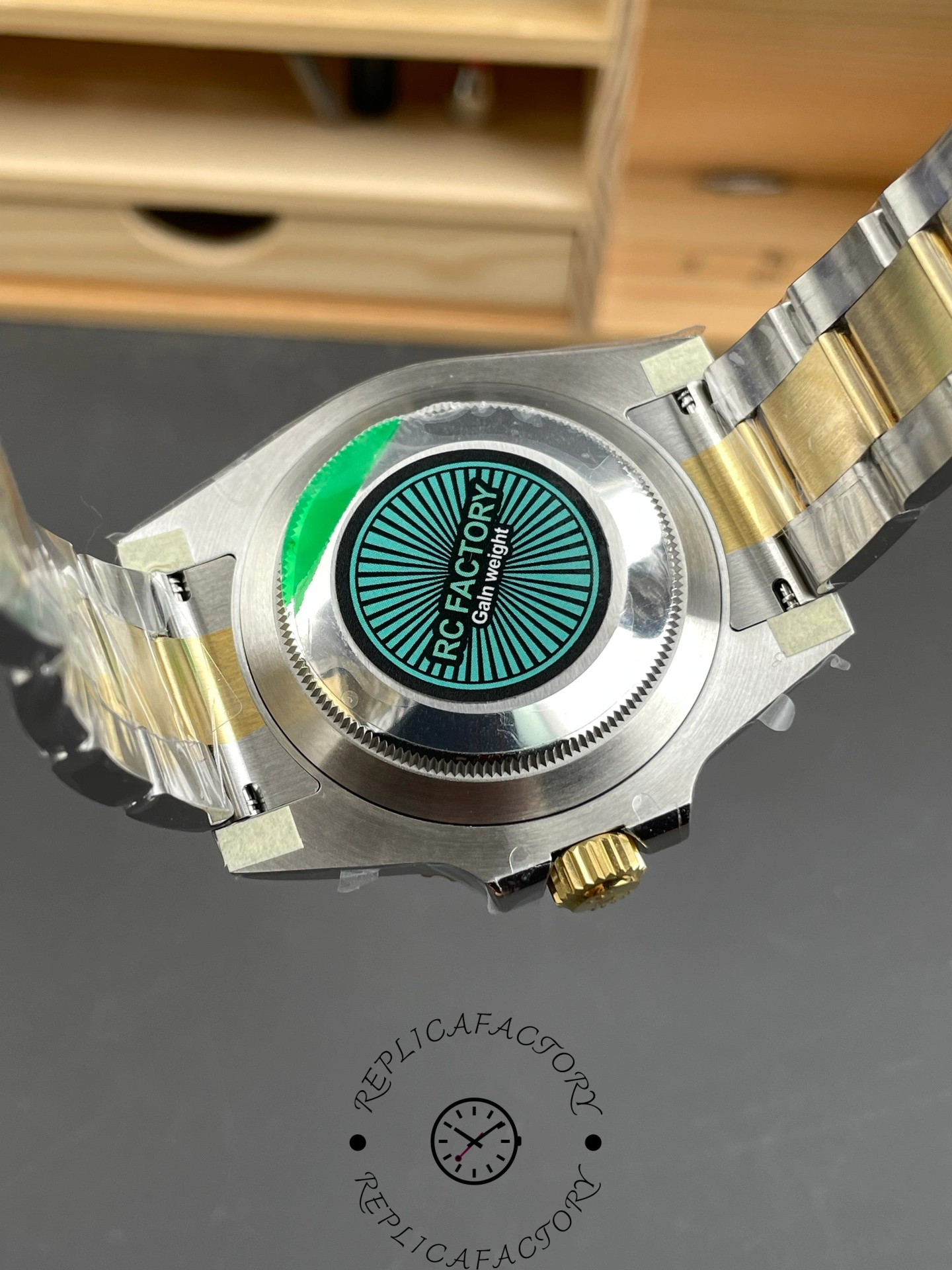 Rolex Submariner 126613LN 0002 caseback with green sticker, screw-down back detail.