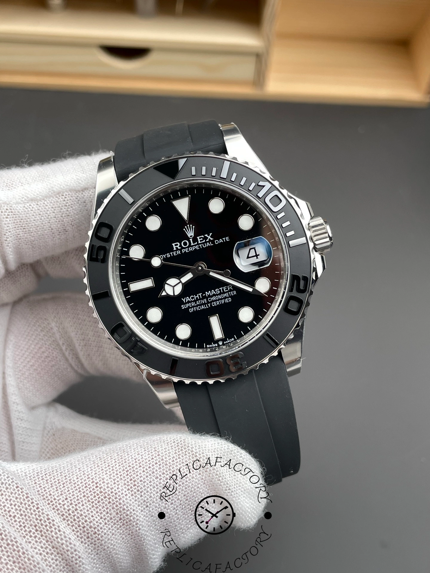 Rolex Yacht-Master 226659 in glove, angled view of black dial and bezel, Oysterflex strap.