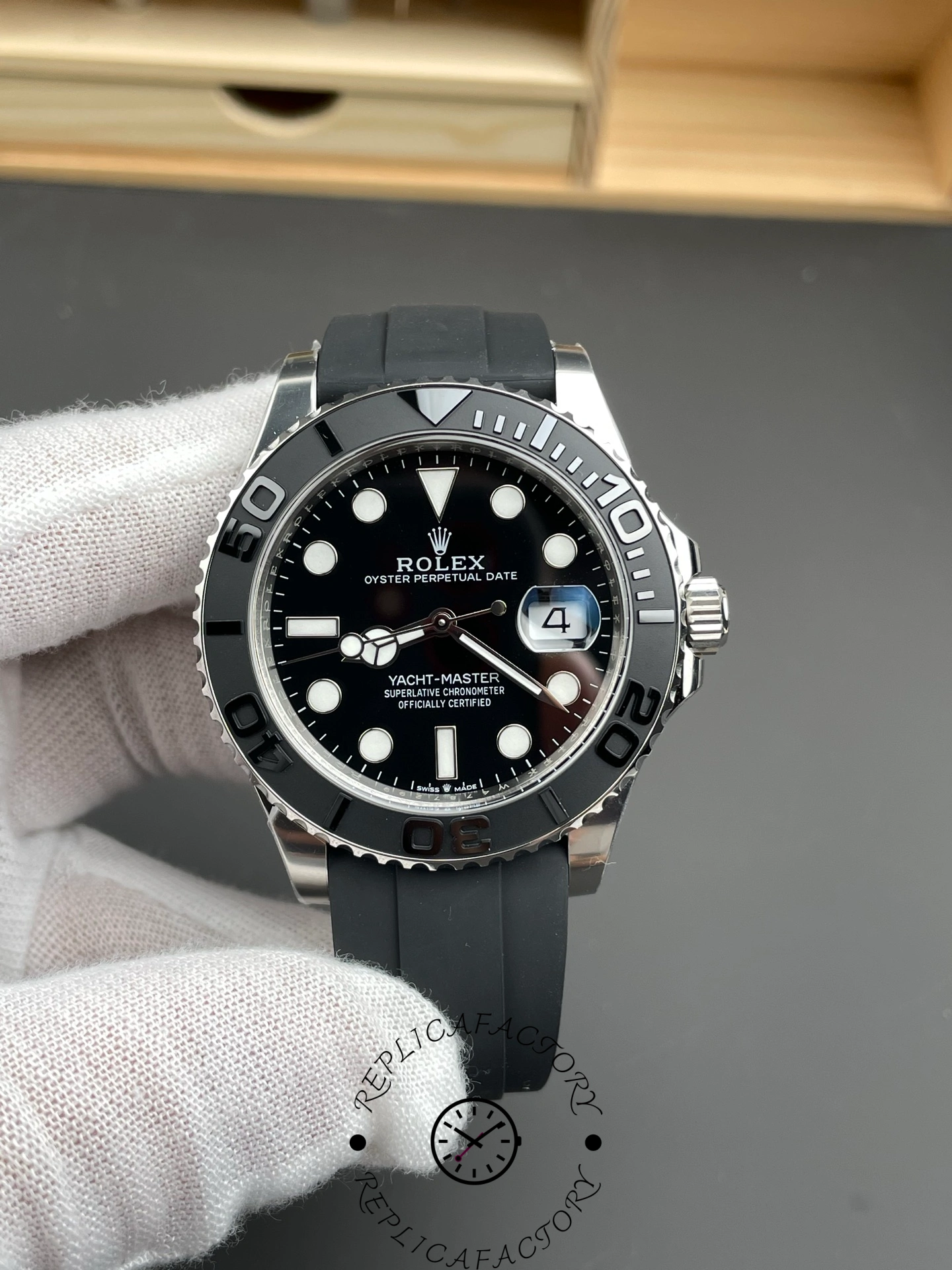 Rolex Yacht-Master 226659 held in glove, black dial and bezel, Oysterflex strap, front view.
