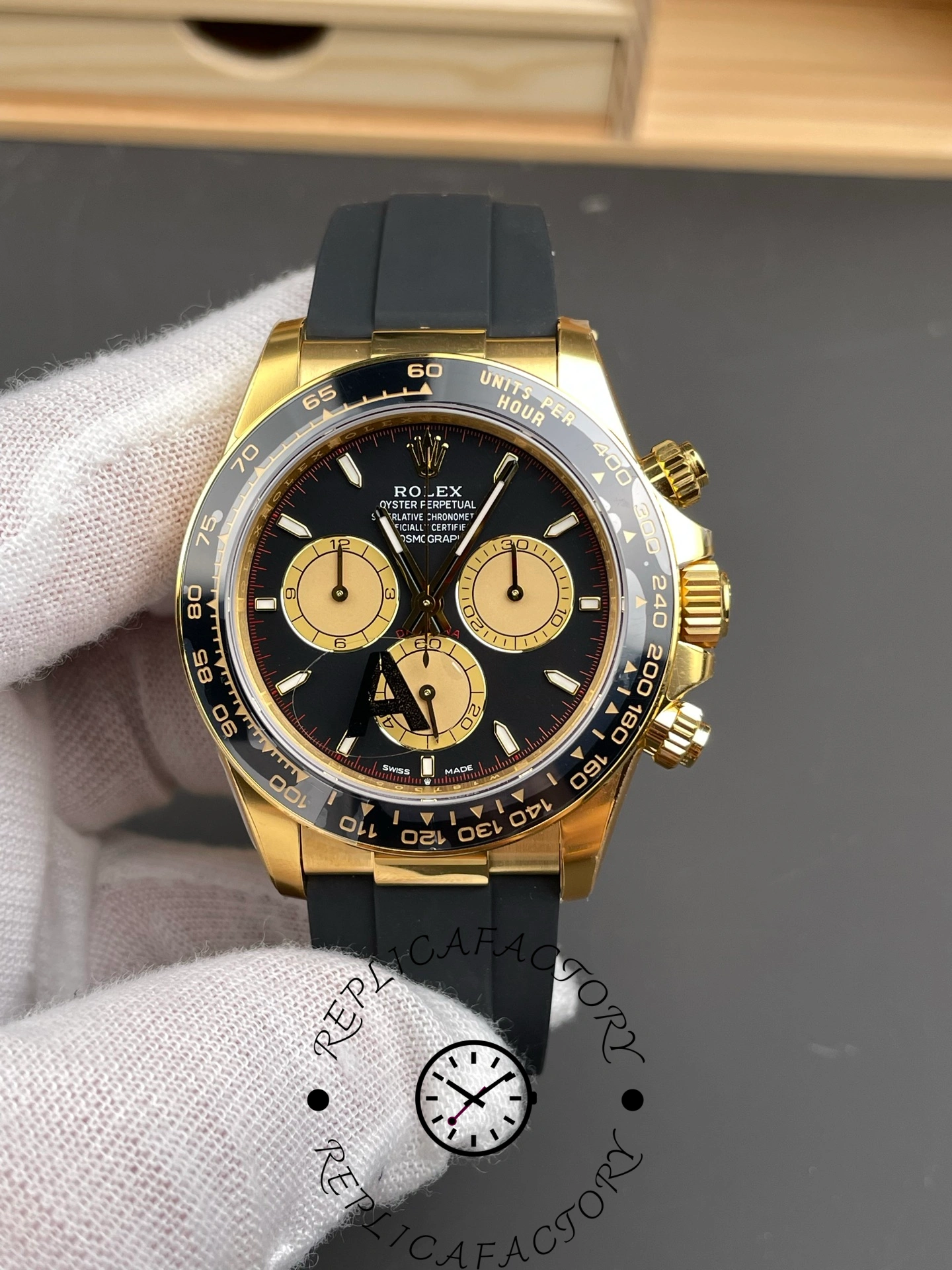 Rolex Daytona 126518LN 0004 on glove, front view, black dial and gold subdials.