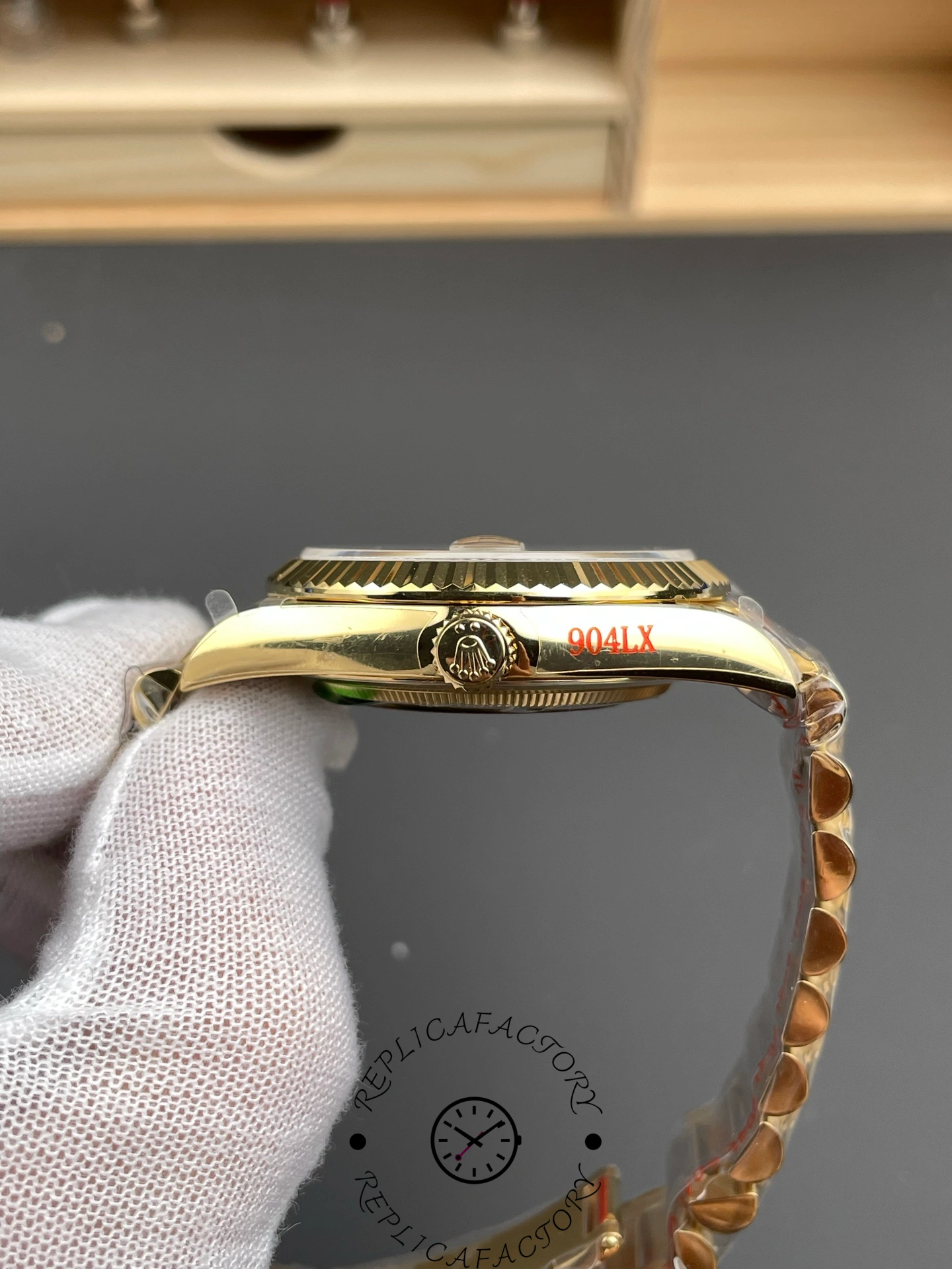 Side profile of the Rolex Day-Date m228238-0005 showing the gold crown and bracelet curve.