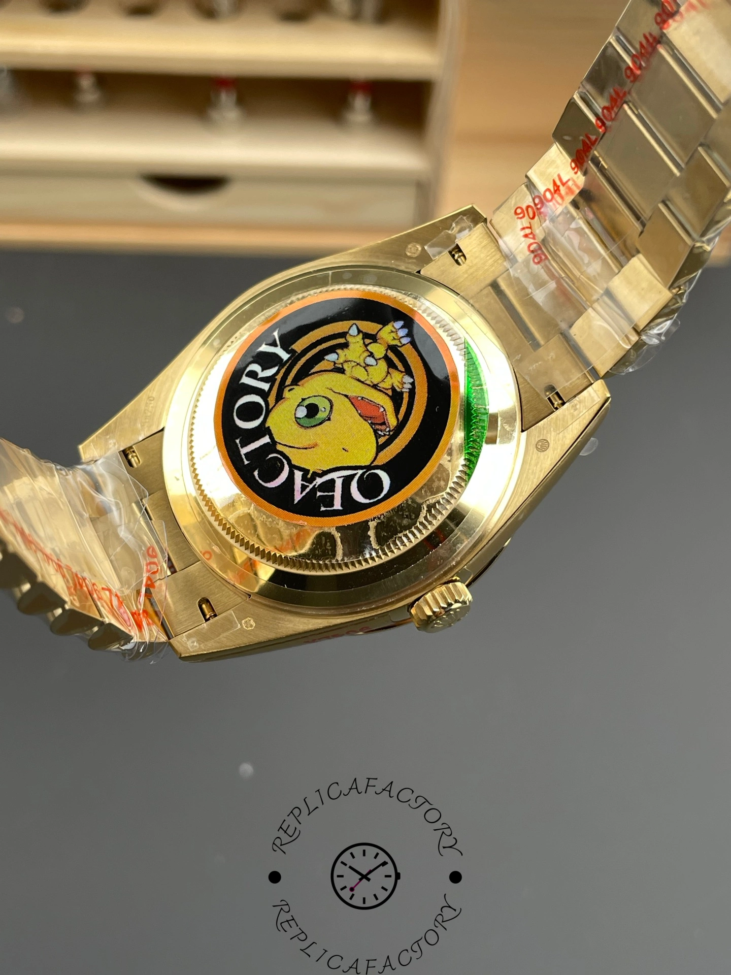 Caseback view of the Rolex Day-Date m228238-0005 showing the rear cover with a colorful factory sticker.