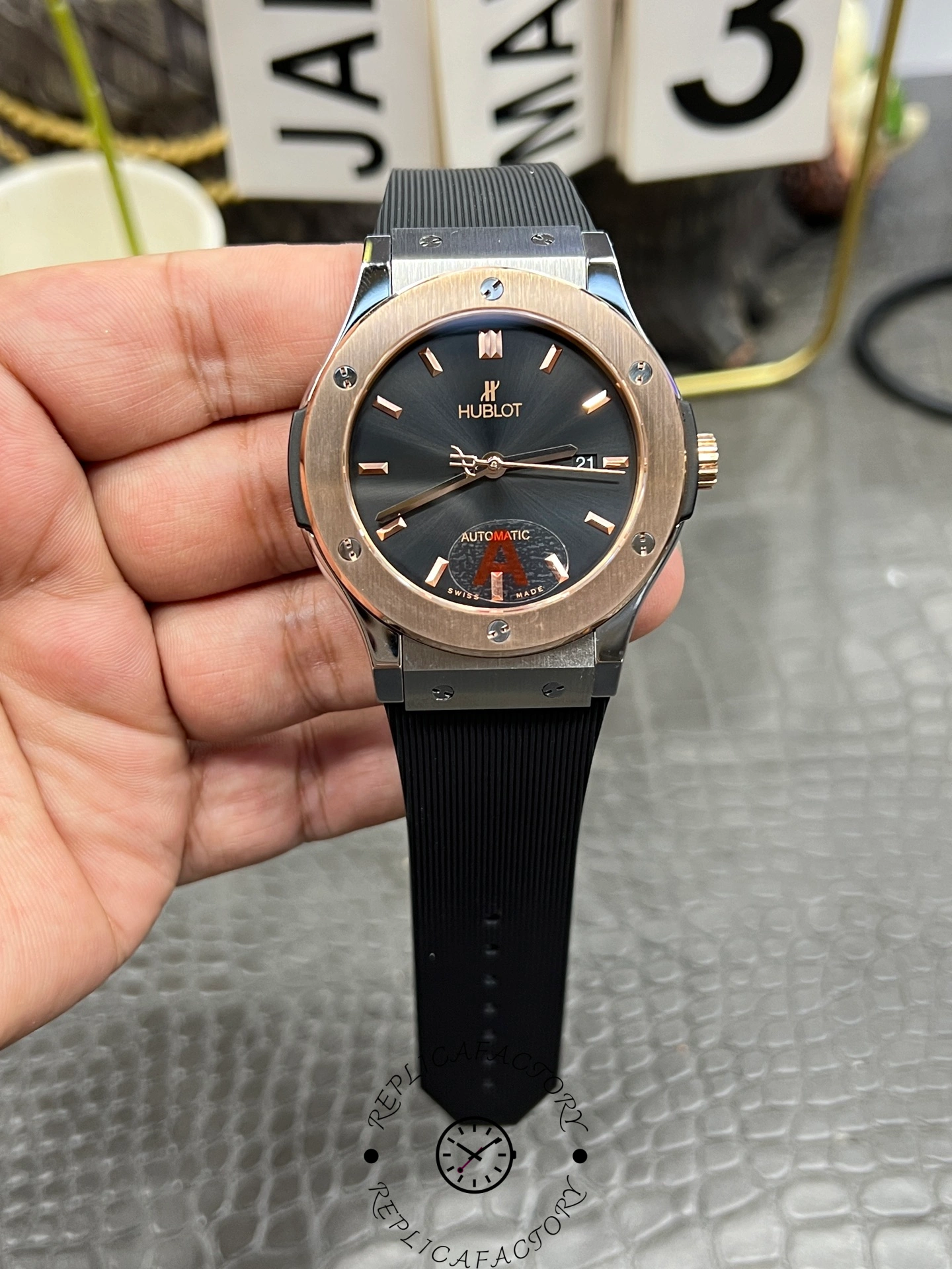 Handheld full watch of Hublot Classic Fusion 542.NO.1181.RX highlighting rose-gold bezel and hour markers.