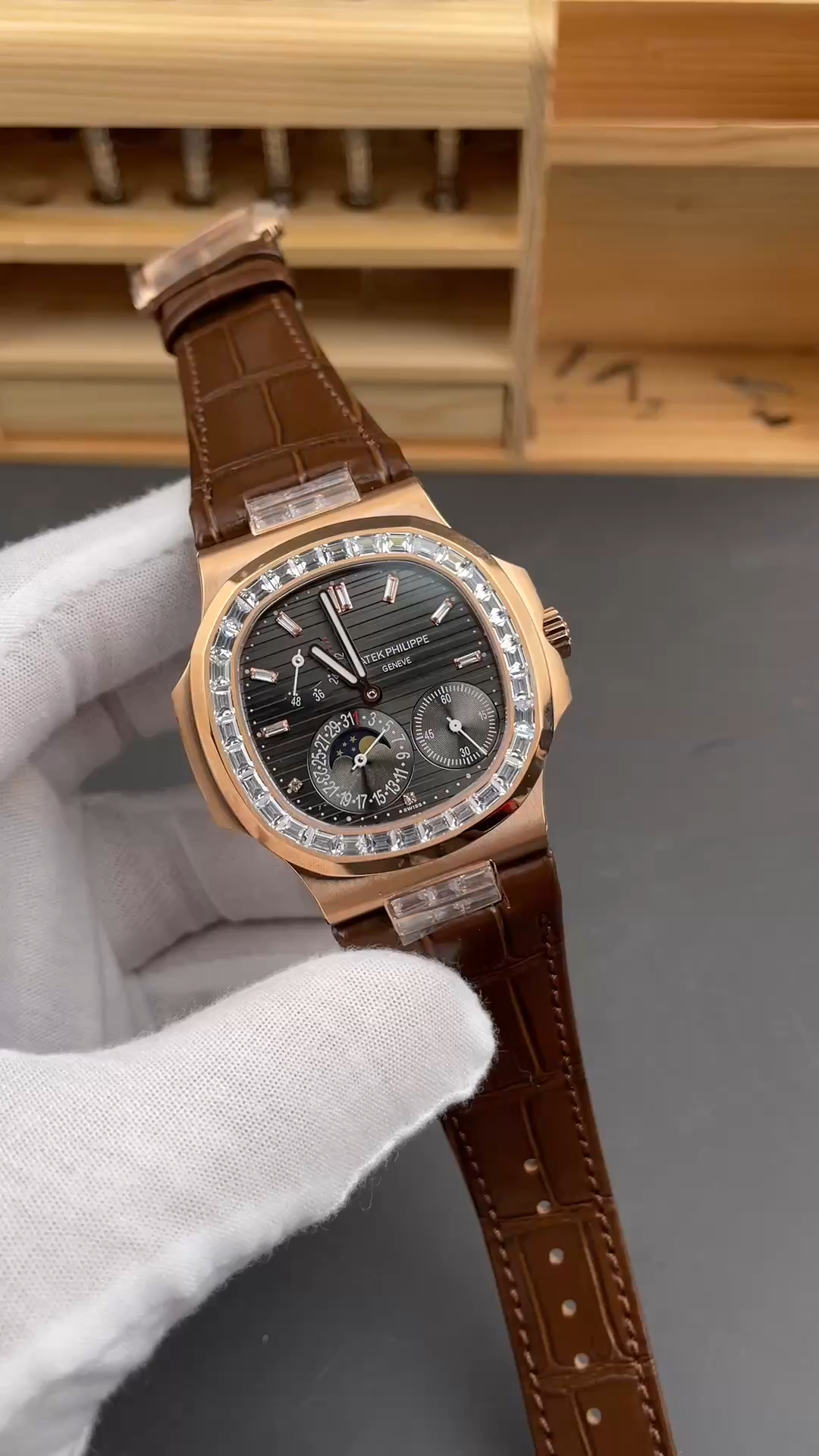 Video: hand-held Patek Philippe Nautilus 5724-001 showing brown leather strap and polished bezel. - Video