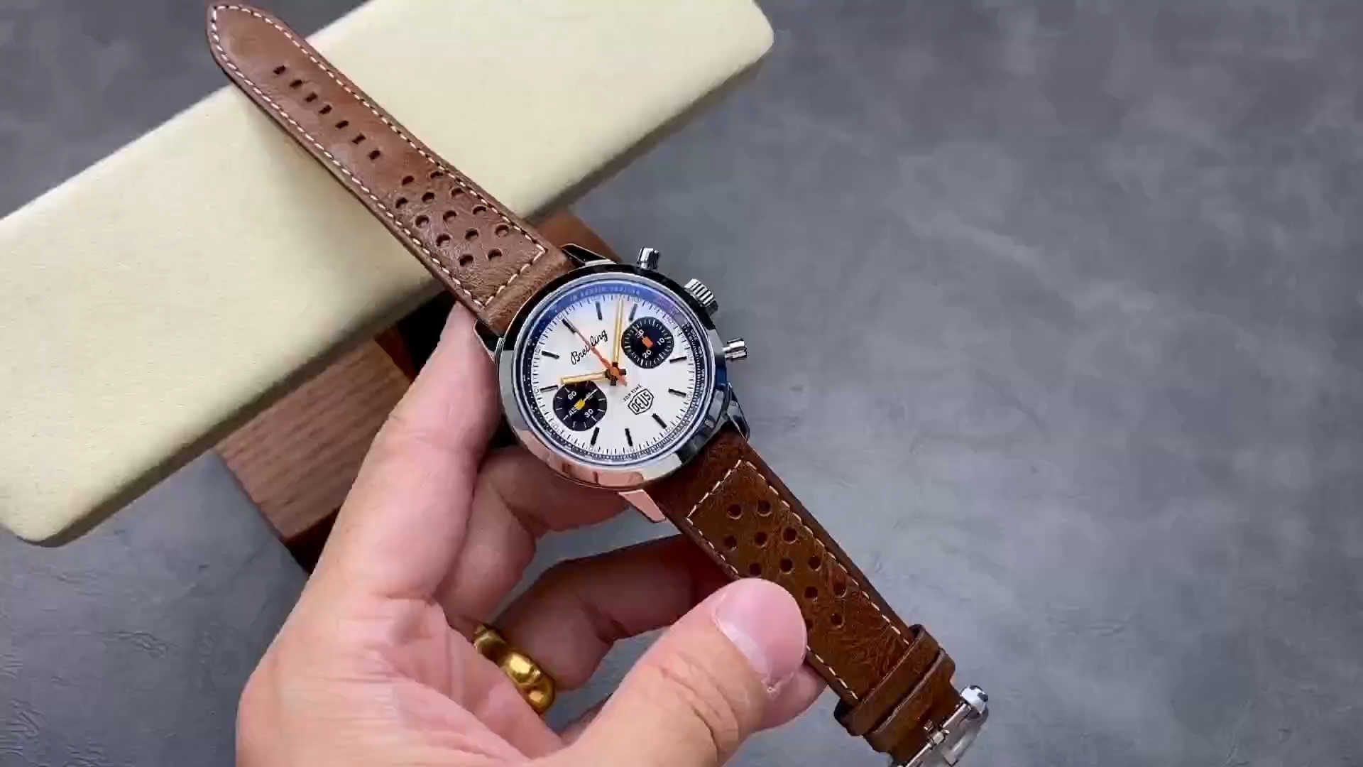 Breitling Top Time Deus A233101A1A1X1, video showing dial and brown leather strap. - Video