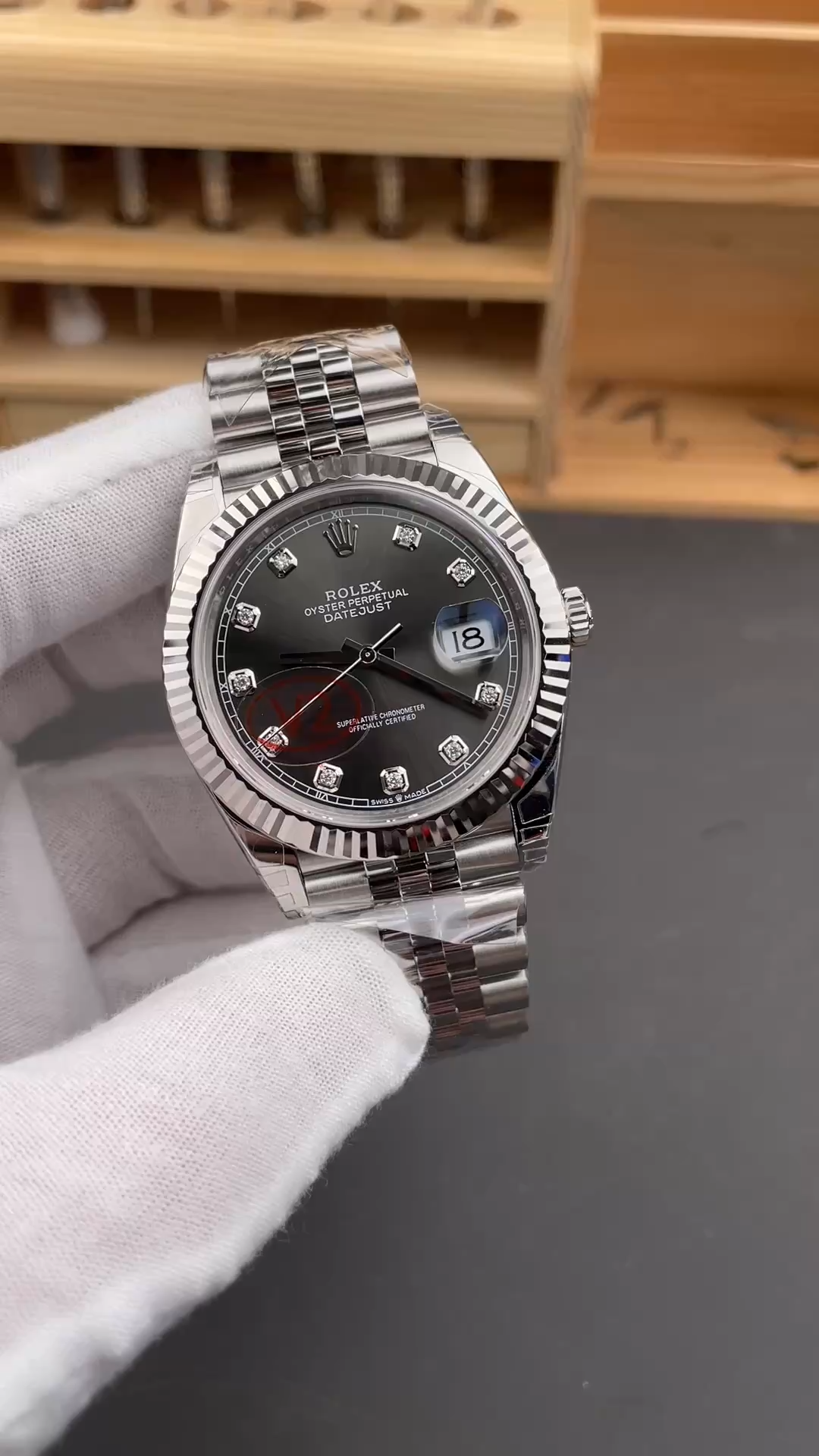 Side profile of the Rolex Datejust m126334-0012 showing the bracelet and case from a gloved hand. - Video