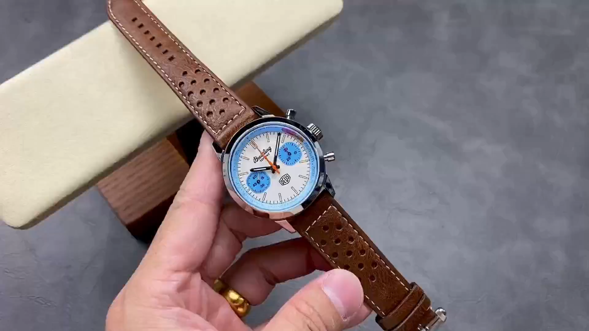 Breitling Top Time Deus A233112A1A1X1, video showing dial and brown leather strap. - Video