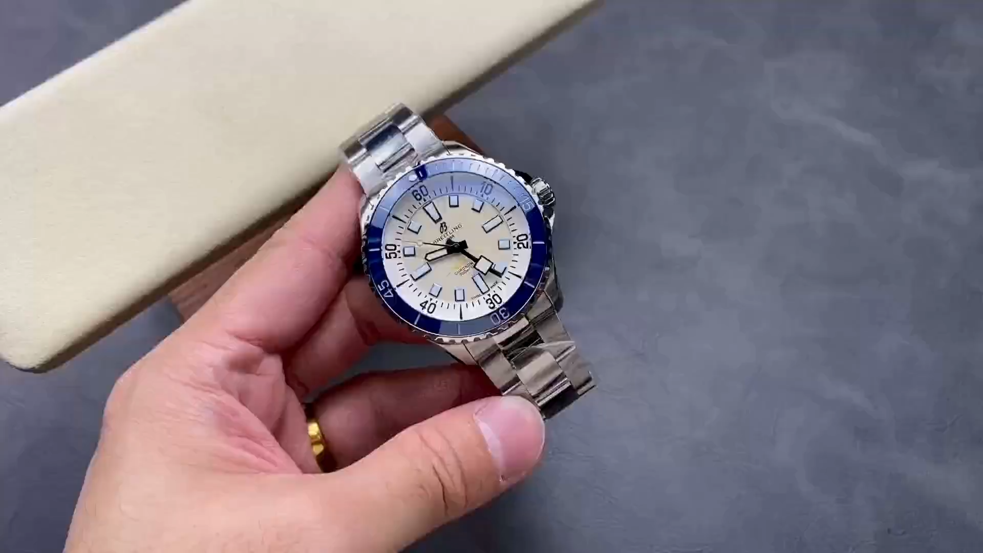 Video: hand-held Breitling Superocean Automatic A17375E71G1A1 showing white dial and steel bracelet. - Video