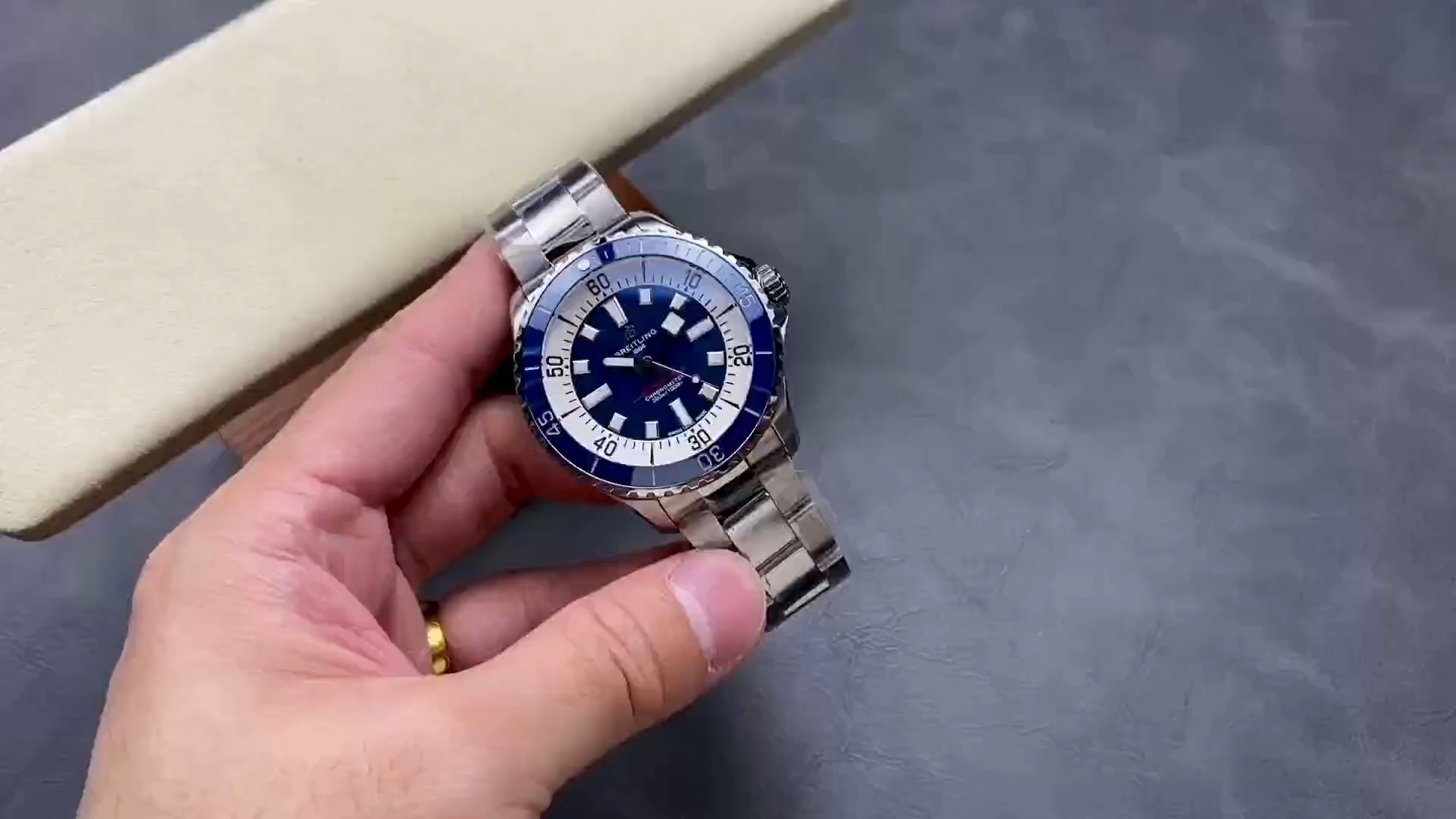 Video: hand-held Breitling Superocean Automatic A17375E71C1A1 showing blue dial and steel bracelet. - Video