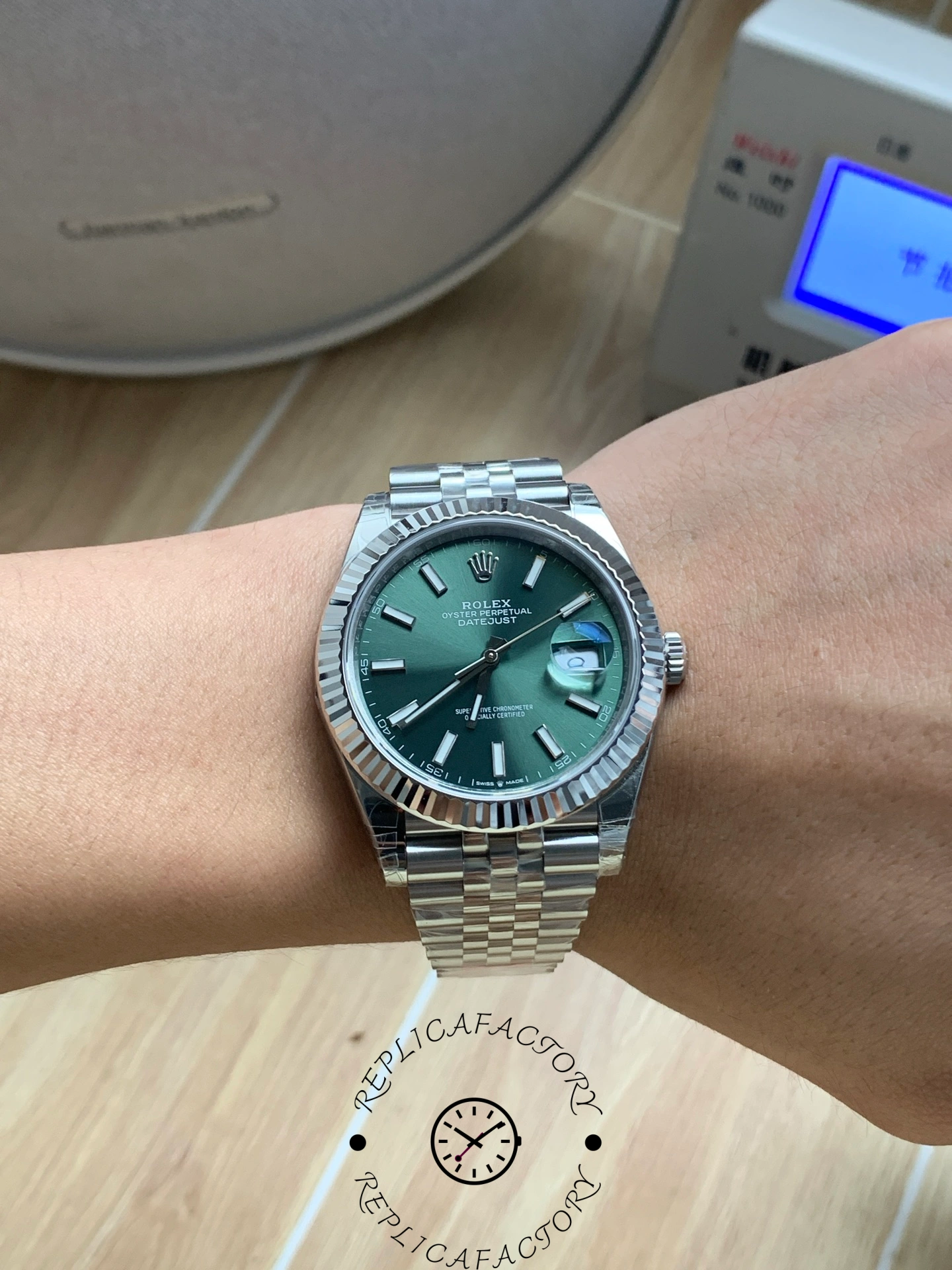 Wrist shot of the Rolex Datejust 126334-0028 with green dial and Jubilee bracelet.
