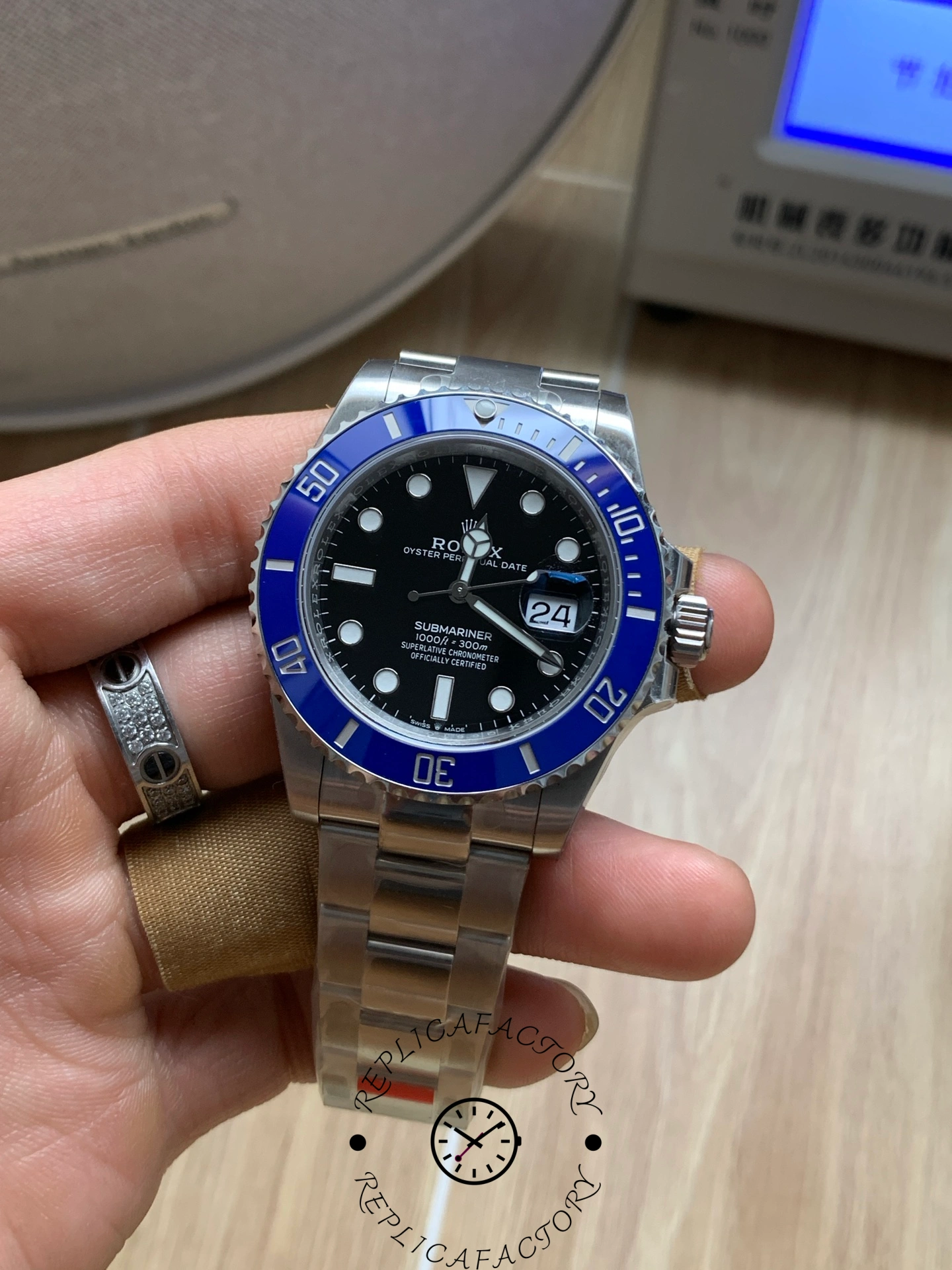 Rolex Submariner 126619LB 0003, front view in hand, blue bezel prominent.