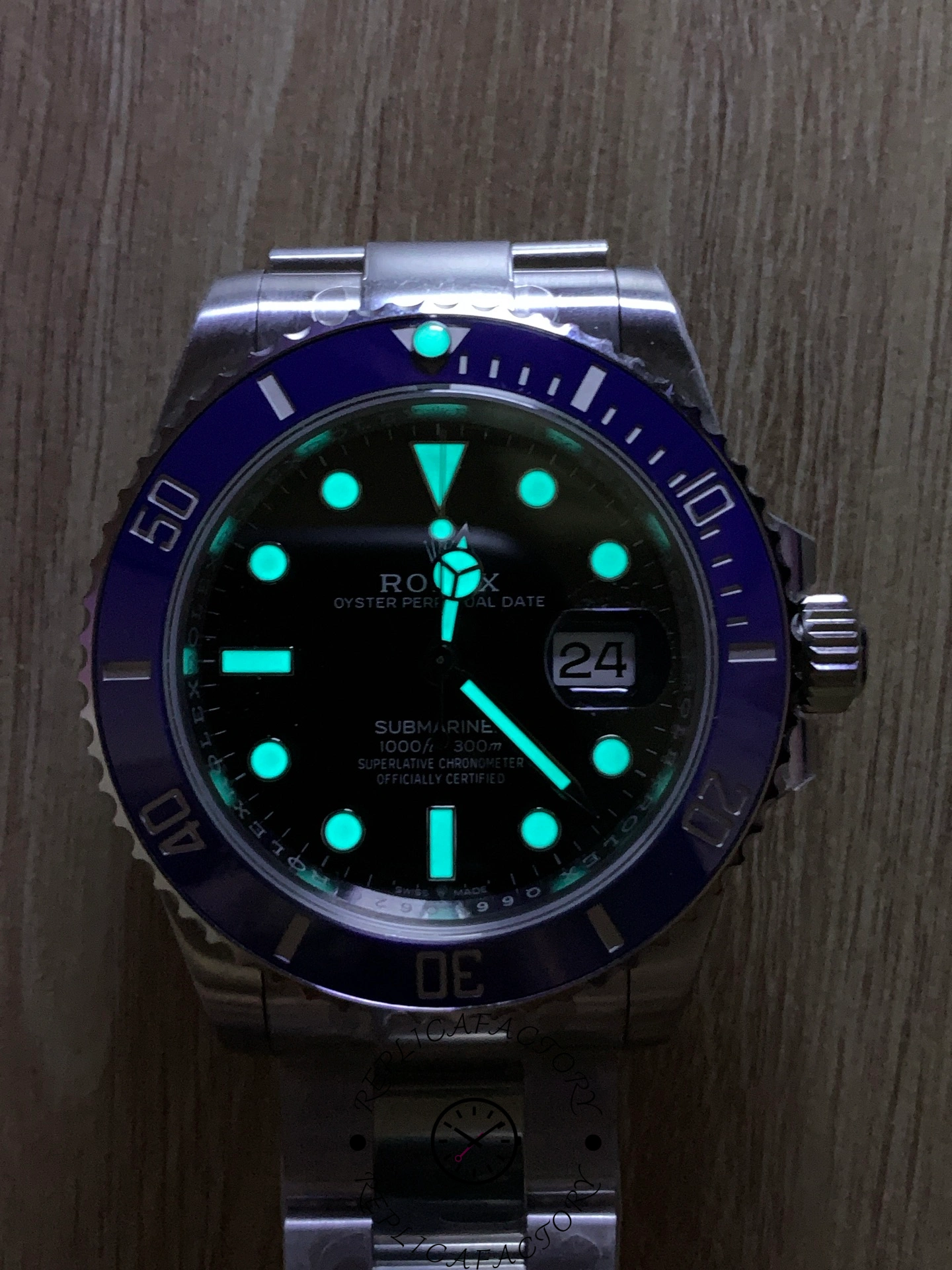 Rolex Submariner 126619LB 0003, lume shot showing glowing markers and hands.